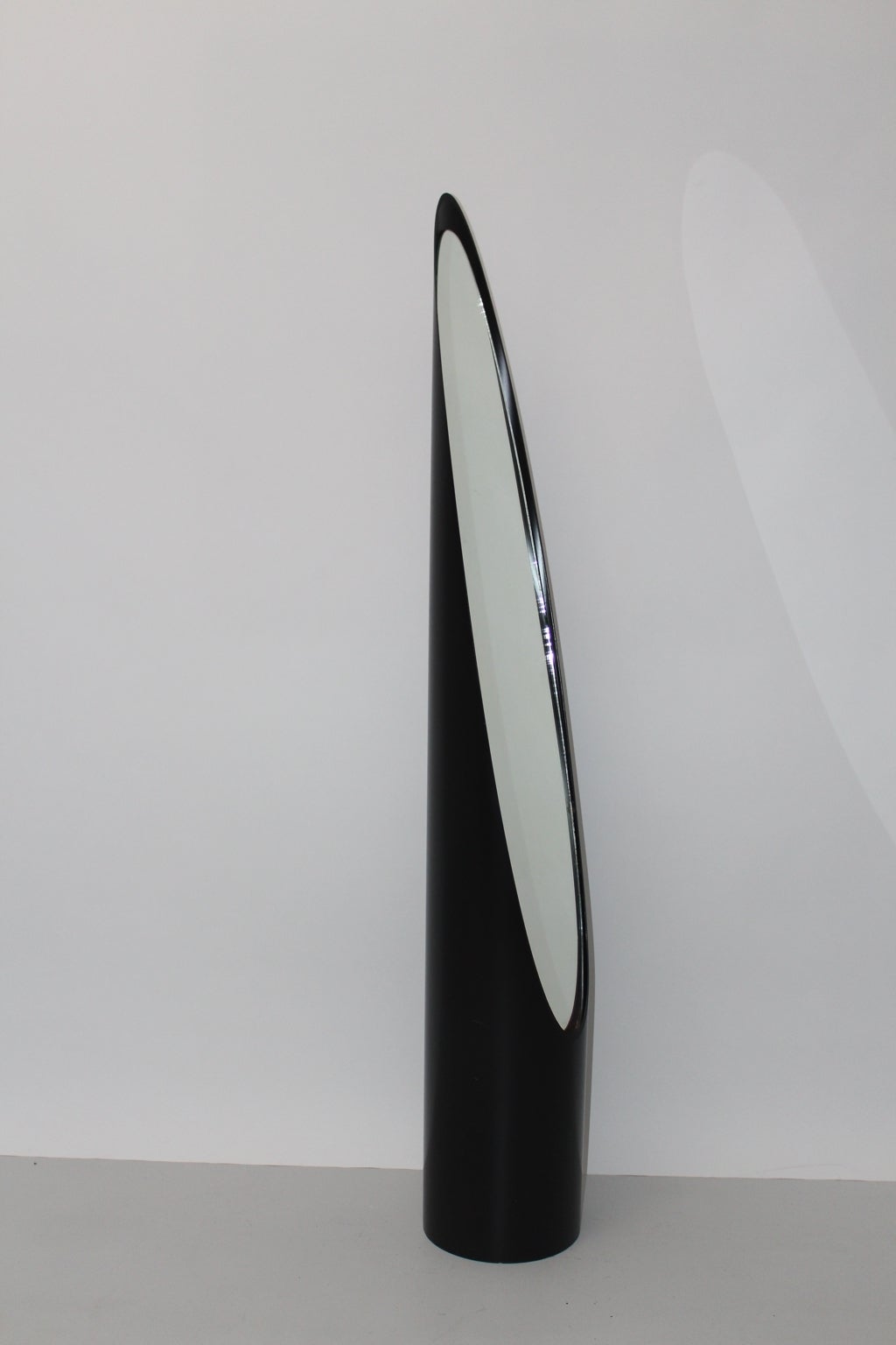 Modernist black vintage floor mirror or full length mirror model lipstick from plastic and mirror glass shaped very similar to Roger Lecal. Not stamped
The frame is made of black plastic and filled with elliptical mirrored glass, while the base