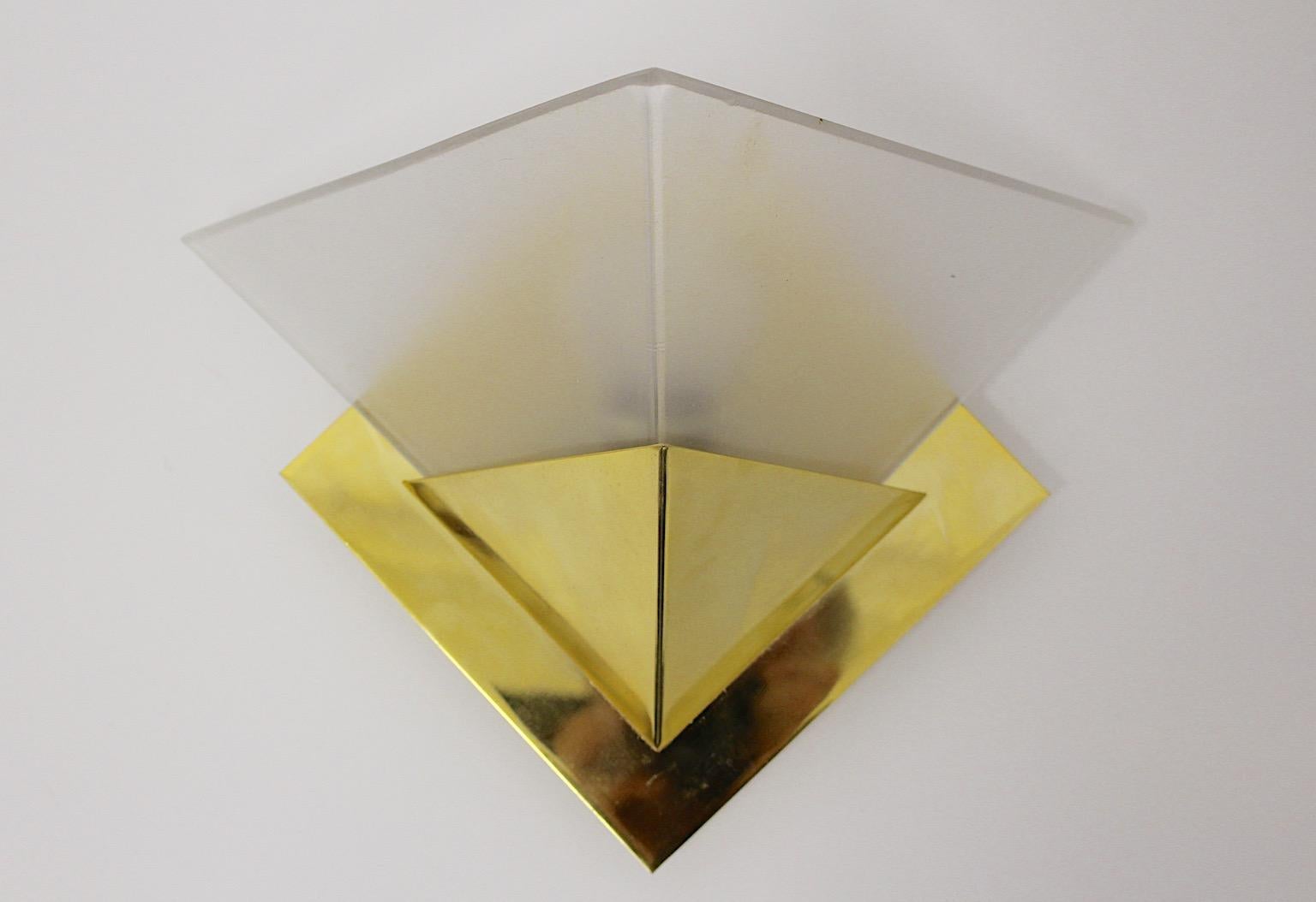 Modernist geometric vintage brass etched glass glass sconces or wall lights, Italy 1970s.
A beautiful set of sconces or wall lights shows a quantity up to nine and feature geometrical shape. These brass sconces are combined with etched glass shades.