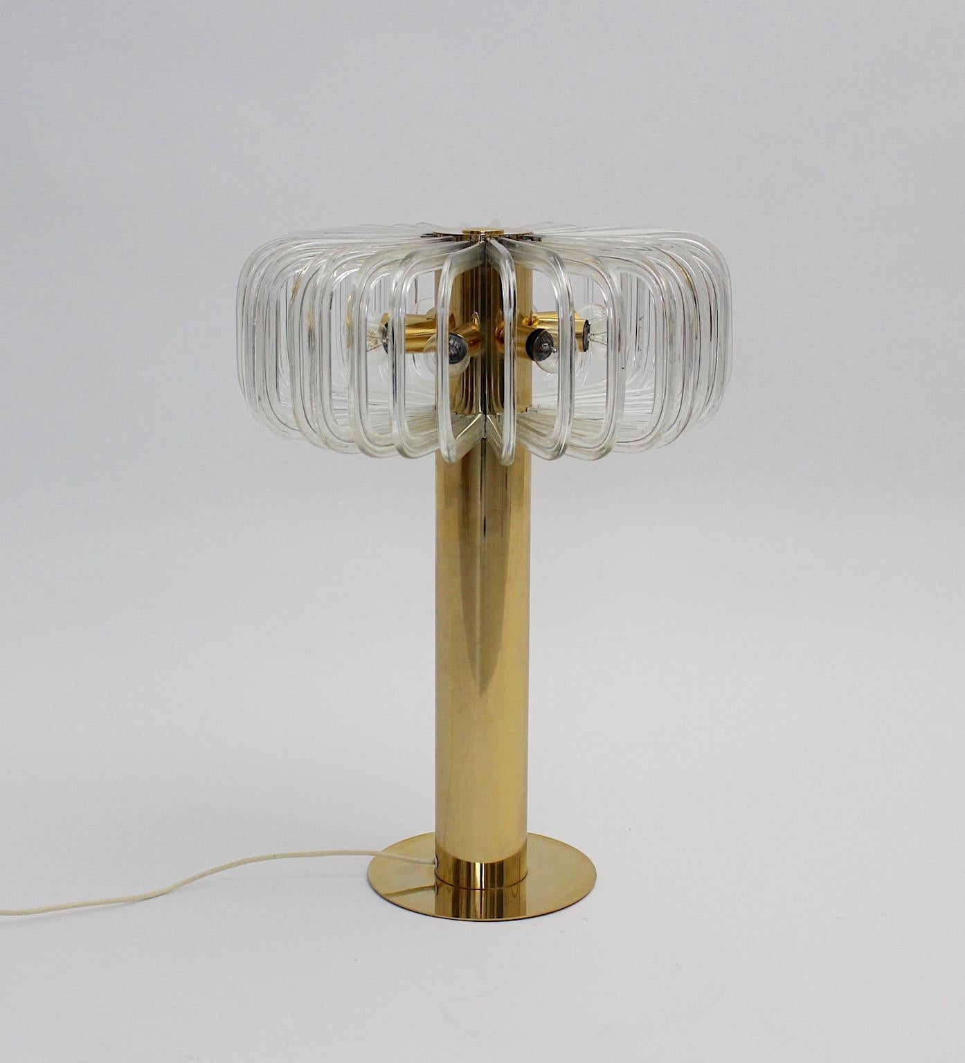 Mid Century Modern vintage table lamp from brass and glass by Cari Zalloni 1960s for Bakalowits Vienna. This gilded brass table lamp Mod. Quazar shows high-quality and impresses through its heavy precious gilded brass base and its 32 curved clear