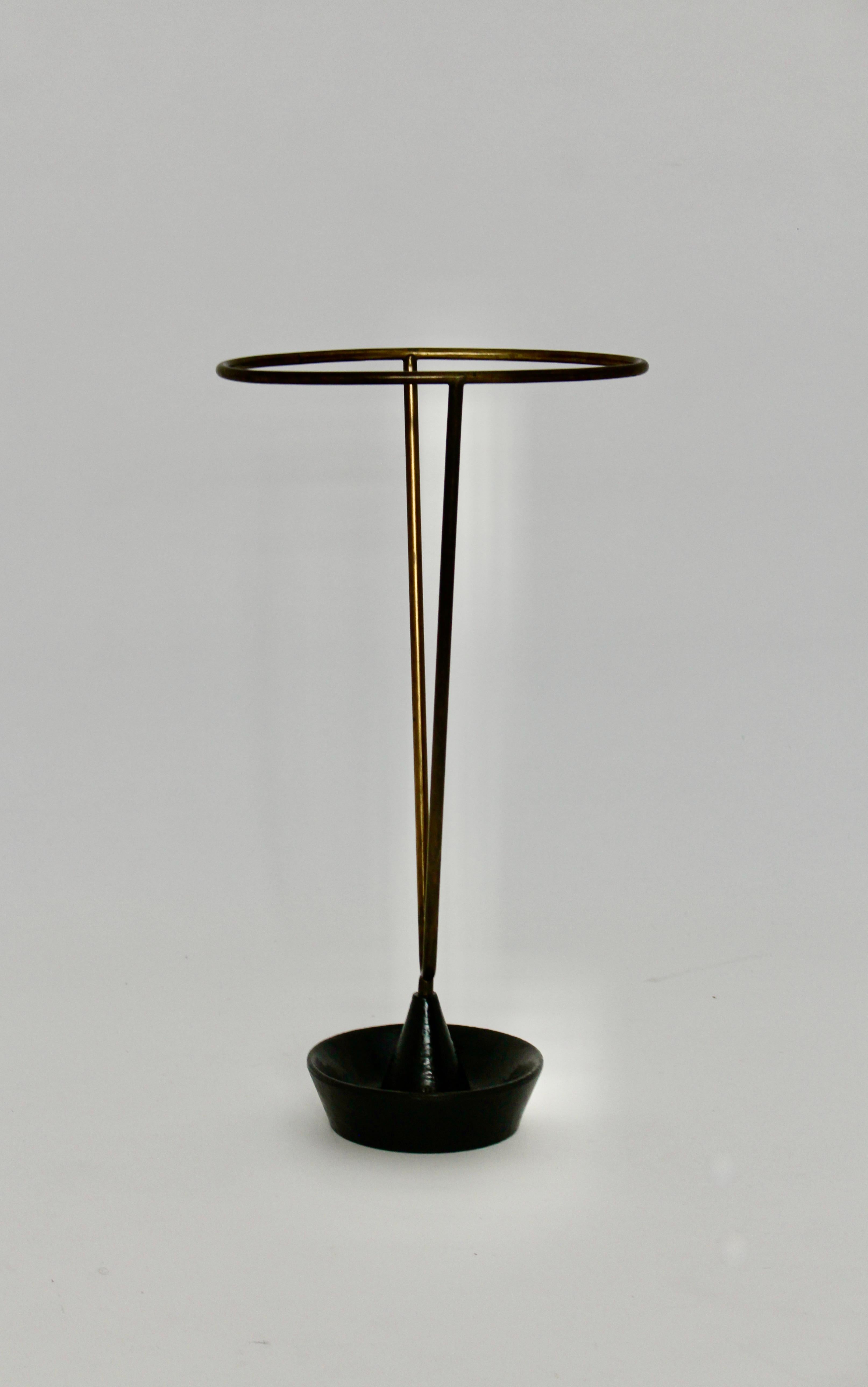 Modernist vintage authentic umbrella stand or cane holder by
Carl Auböck for workshop Auböck 1950s Vienna.
The wonderful umbrella stand or cane holder from black lacquered metal and brass shows original condition with beloved signs of age and use