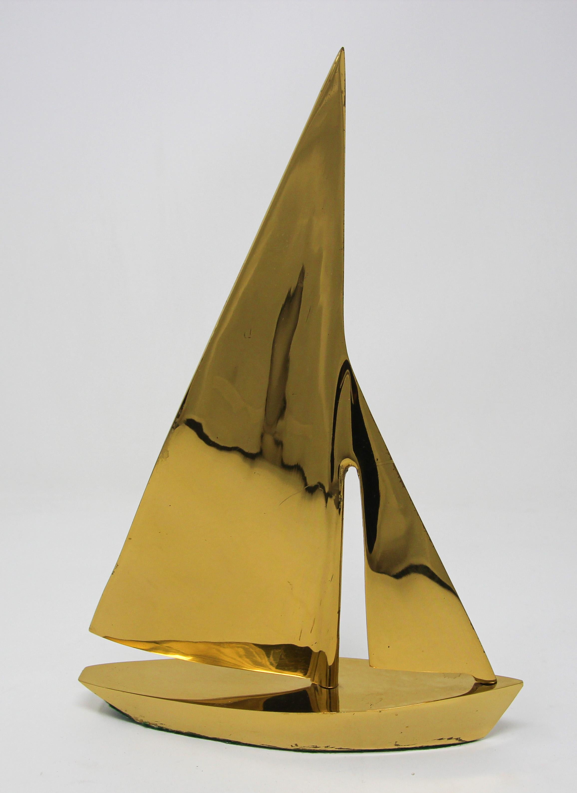 Large Modernist small polished brass sailboat paperweight.
A sturdy and sleek midcentury brass sailboat.
Vintage beautiful midcentury figural solid brass sailboat, figurine would be perfect for adding a touch of nautical flair to a coffee table,