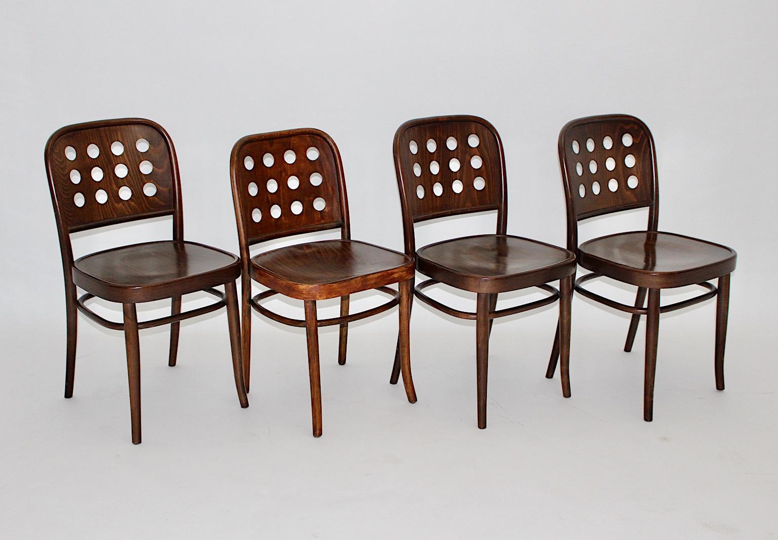 Modernist Josef Hoffmann style 4 vintage dining chairs or easy chairs beech bentwood in chocolate brown color 1990s in an amazing shape.
A beautiful set with four ( 4 ) dining chairs or easy chairs in the style of Josef Hoffmann, 1990s. 
While the