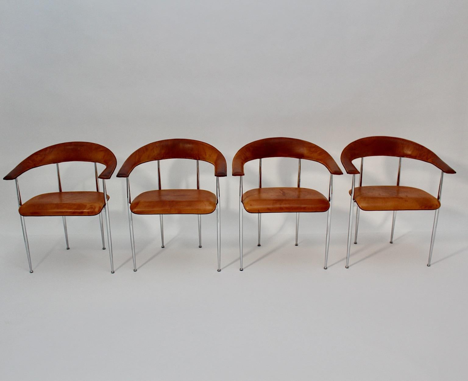Modernist vintage four ( 4 ) dining chairs or armchairs from cognac brown leather and chromed base by Fasem, Italy 1980s.
A beautiful set of four ( 4 ) dining chairs or armchairs from thick stitched leather in cognac brown color with chromed metal
