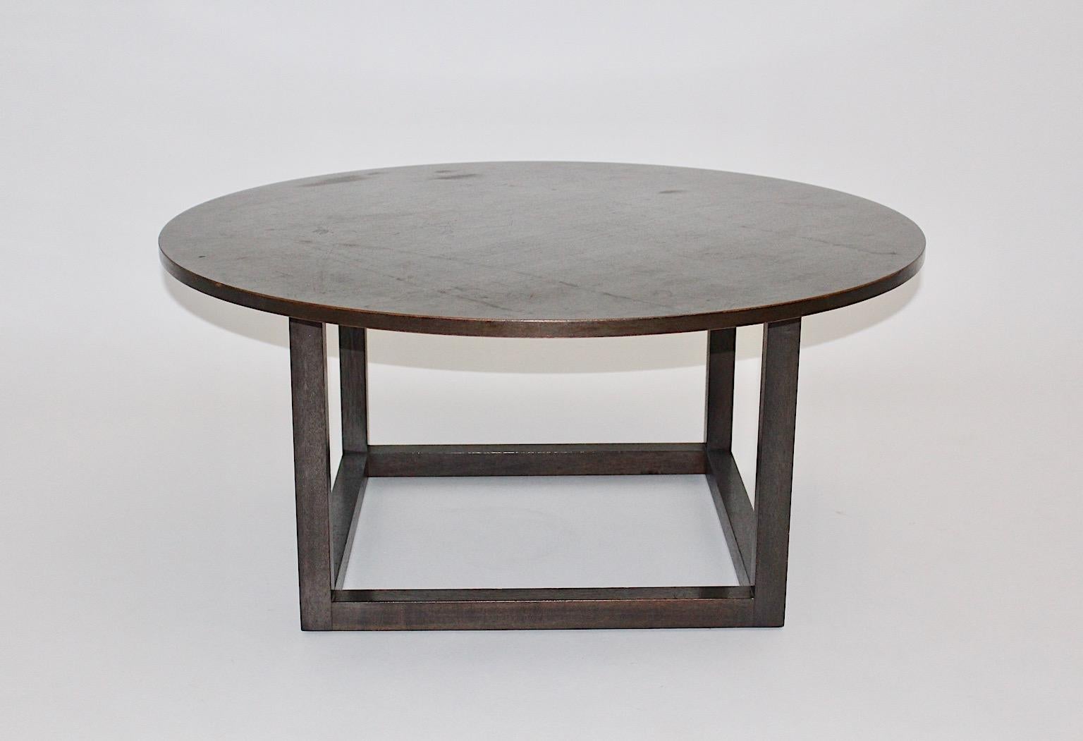 Modernist vintage sofa table or coffee table from solid oakwood coffee table in the style of Josef Hoffmann, Vienna , 20th century.
This gorgeous sofa table from stained solid oakwood topped with a circular plate , while the base shows rectangular