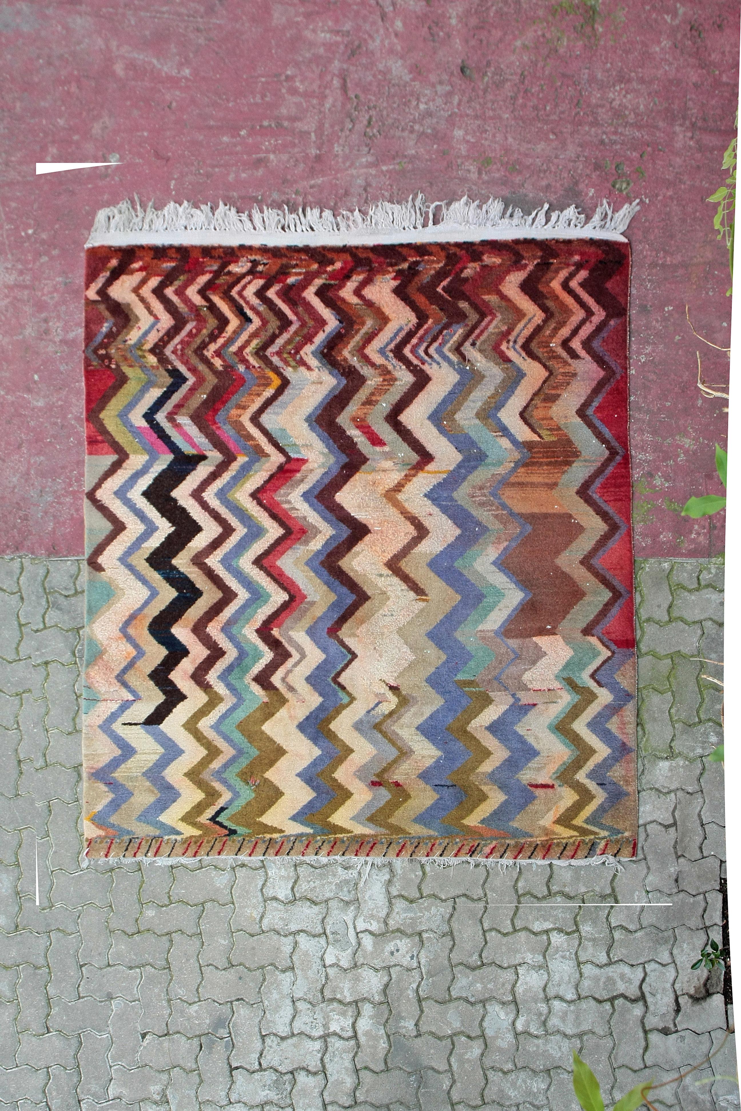 A very rare and unusual village rug characterized by a design composed of parallel multicolored zig-zag elements similar to thunderbolts. Patterns such as this were probably inspired by the geometric designs of the Art Deco period and are an example