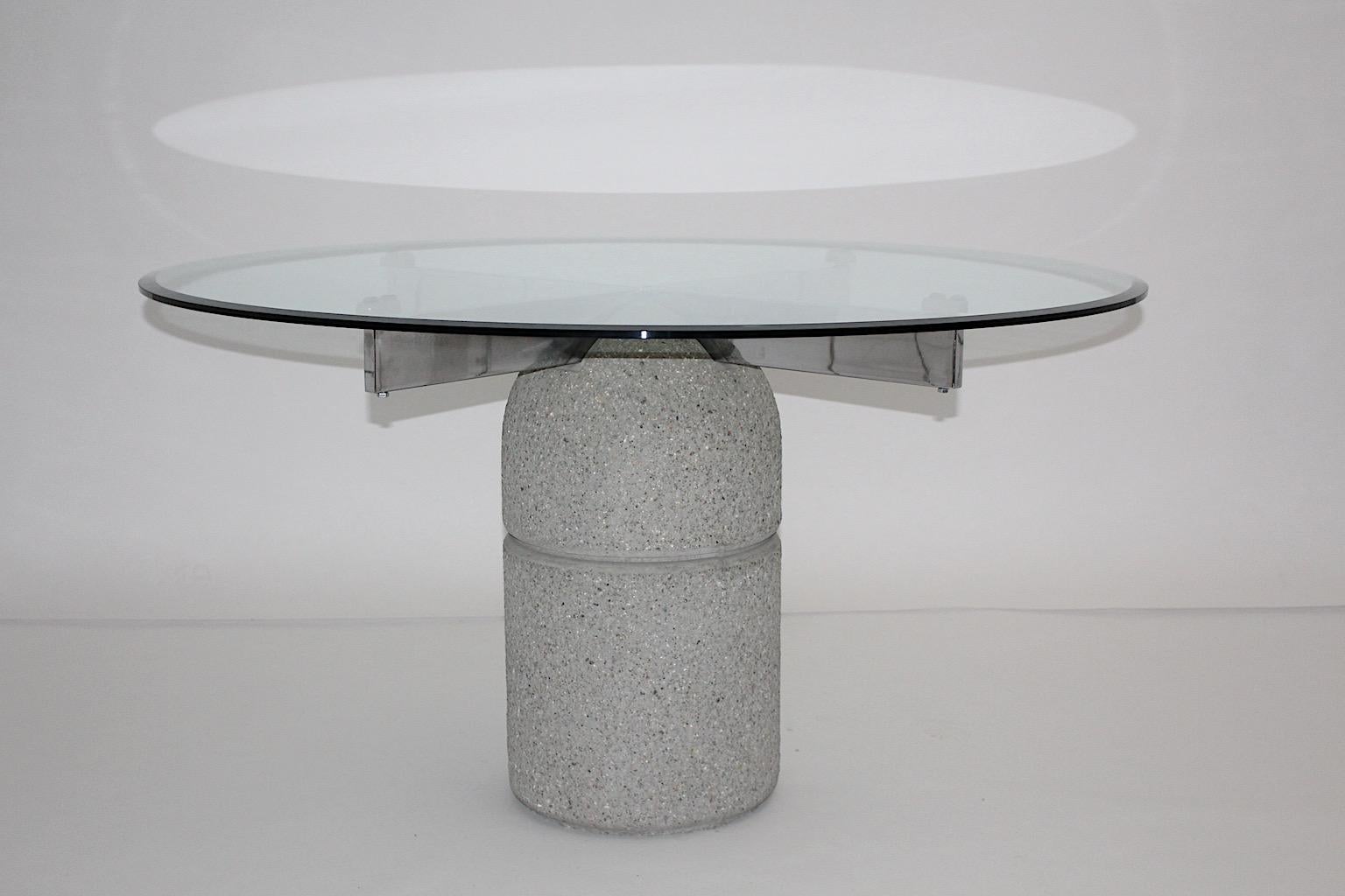 Mid Century Modern vintage dining table Paracarro from stone by Giovanni Offredi 1973, Italy and executed by Saporiti.
The circular base from stone shows a chrome cross for placing the original round clear glass top and features a beautiful