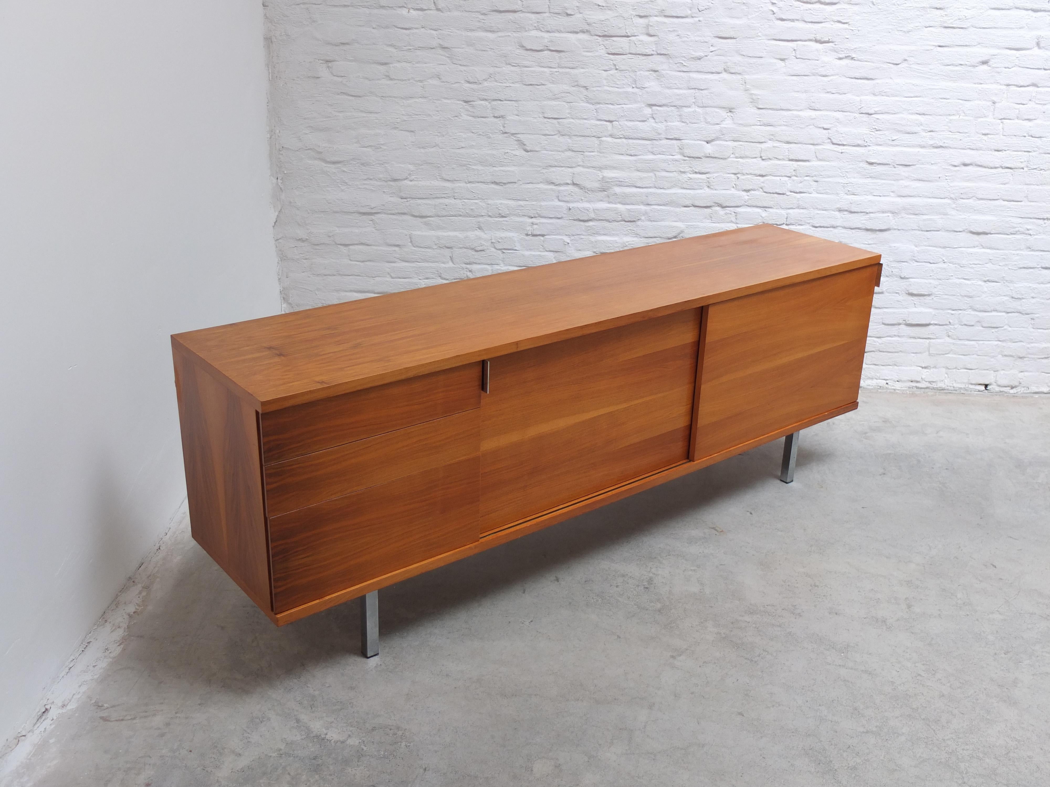 Stunning sideboard designed by Hans Konëcke for Tecta circa 1960. A very sleek and minimalistic design with sliding doors and 4 drawers in the style of of Florence Knoll. This model is rarely seen and this example is made of walnut with a beautiful