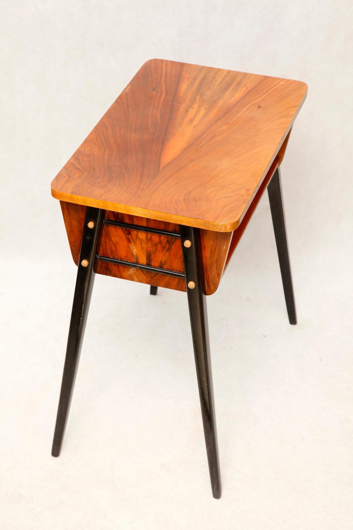 One of the most successful mass designs from the People's Republic of Poland. Simplicity and functionality. The soaring, unseen table serving as a stand for the radio. Open chamber under a small tabletop, four slim, black tapering legs coming out of
