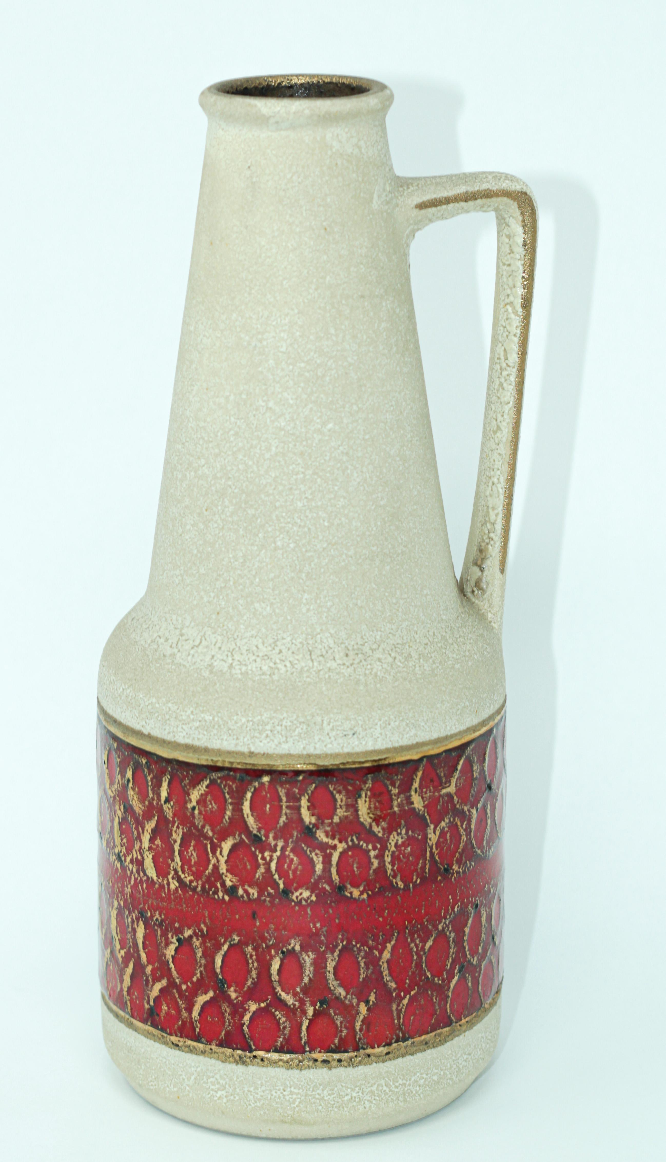 1950s ceramic Modernist West German Studio pottery vase with handle, Germany Bauhaus.
Midcentury ceramic fat lava glaze volcanic pottery vase.
Vibrant vase in an orange, red, cream lava finish.
Straightforward and minimalistic design of the 1960s