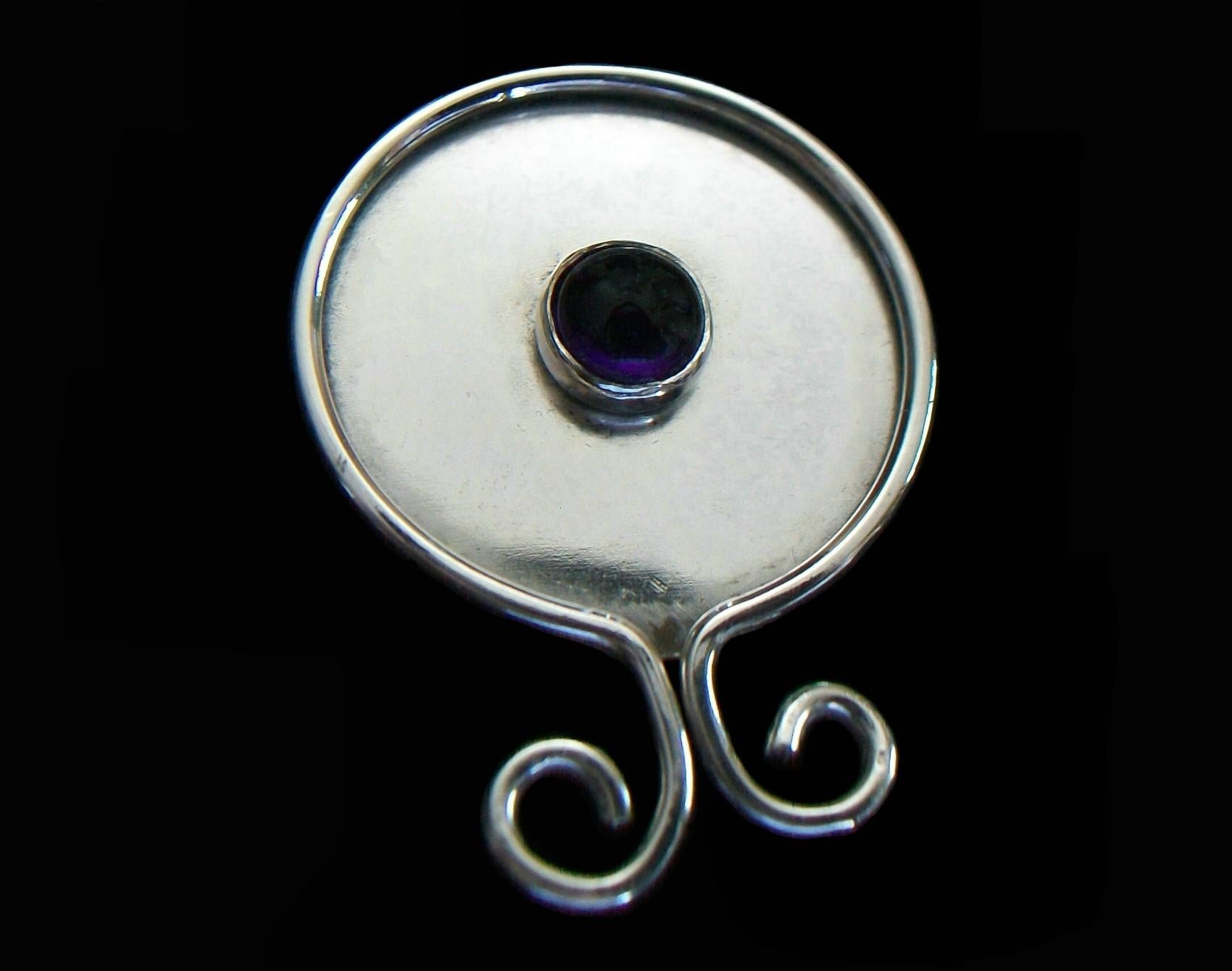 Modernist white metal and round cabochon amethyst brooch - featuring a bezel set amethyst to the center (approximately 5 mm. Diameter x 3 mm. Deep = .53 total carat weight) - the white metal tarnishes and isn't magnetic - completely hand made -