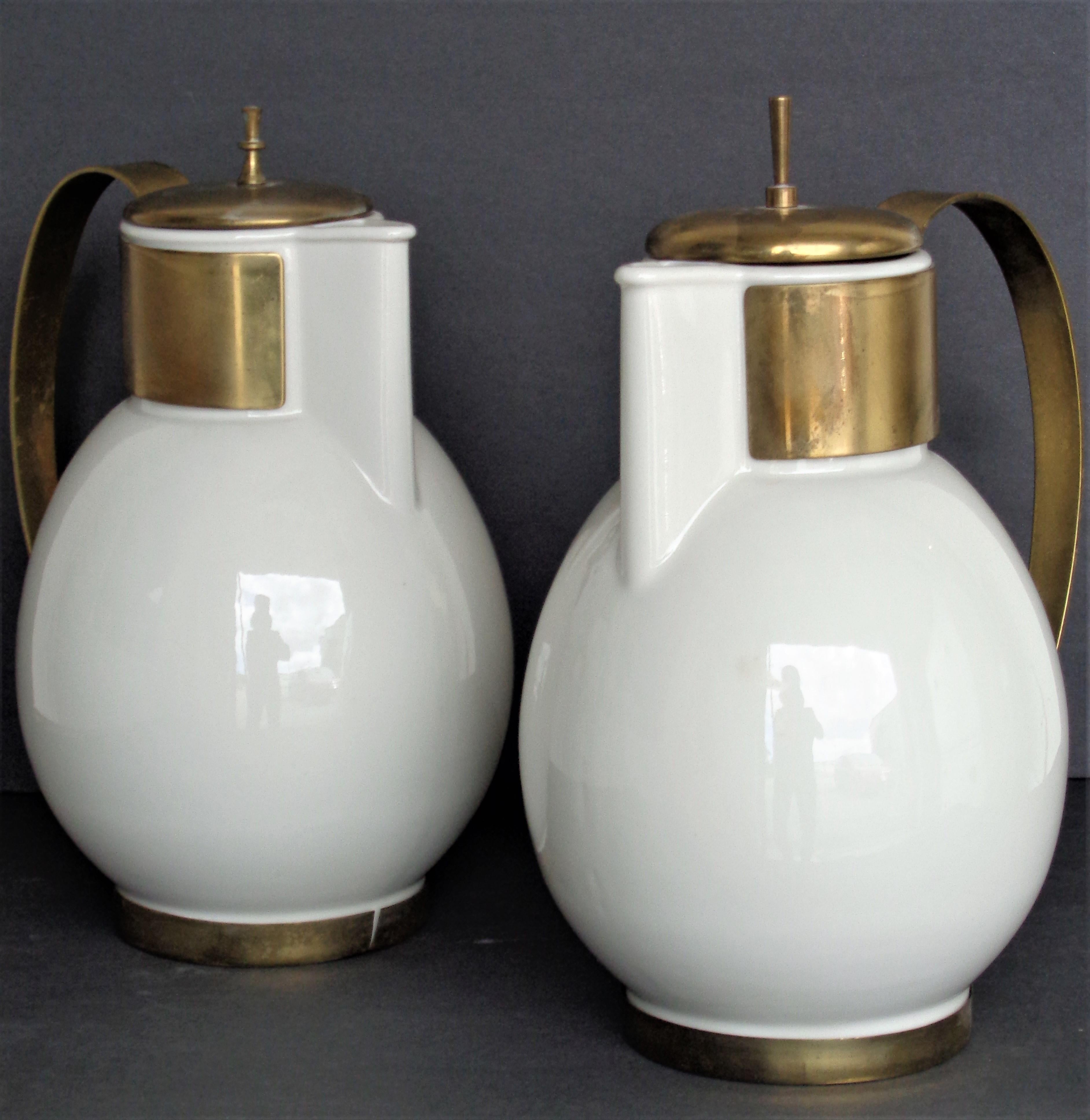 A near pair of heavy white porcelain and brass fitted coffee servers by German born designer Ernest Sohn. Great looking Bauhaus inspired modernist serving pieces. Circa 1950. Look at all pictures and read condition report in comment section.