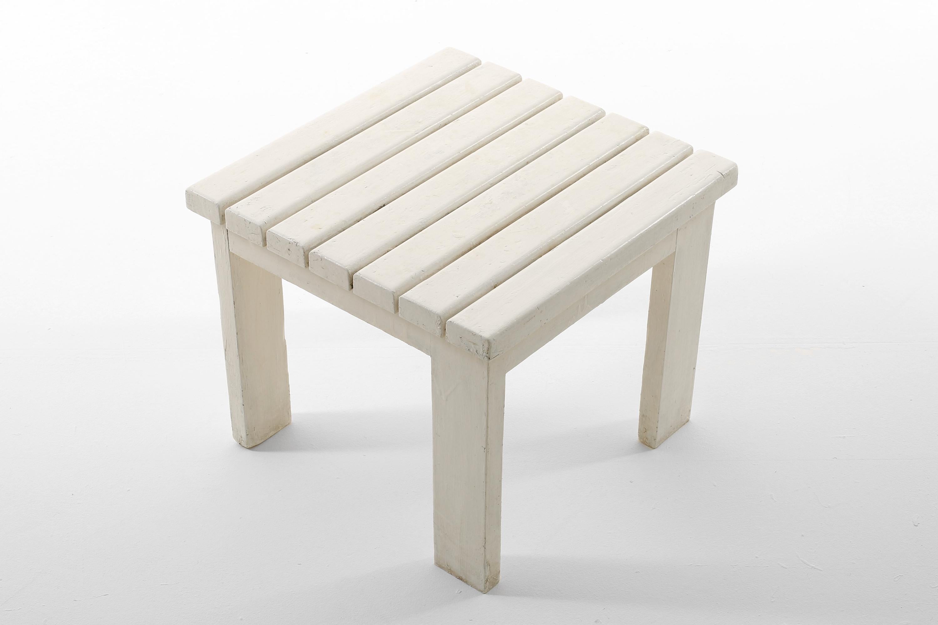 A modernist white painted wooden side table with slatted top and offset legs by Jacques Quinet. Probably an outdoor or poolside table, privately commissioned for a villa in Martigues. French, 1967.