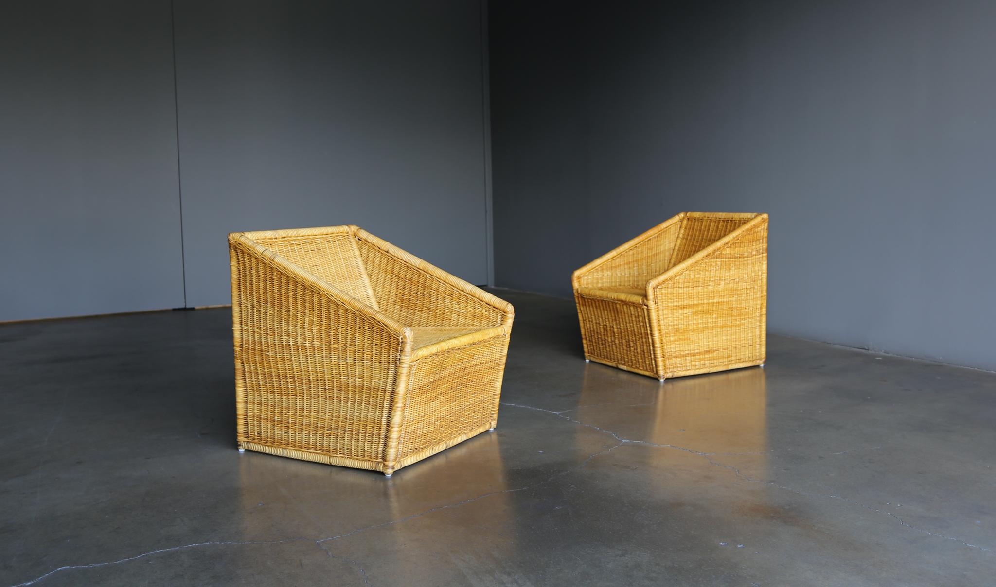 Modernist wicker Rattan lounge chairs, circa 1965. This pair has been expertly restored.