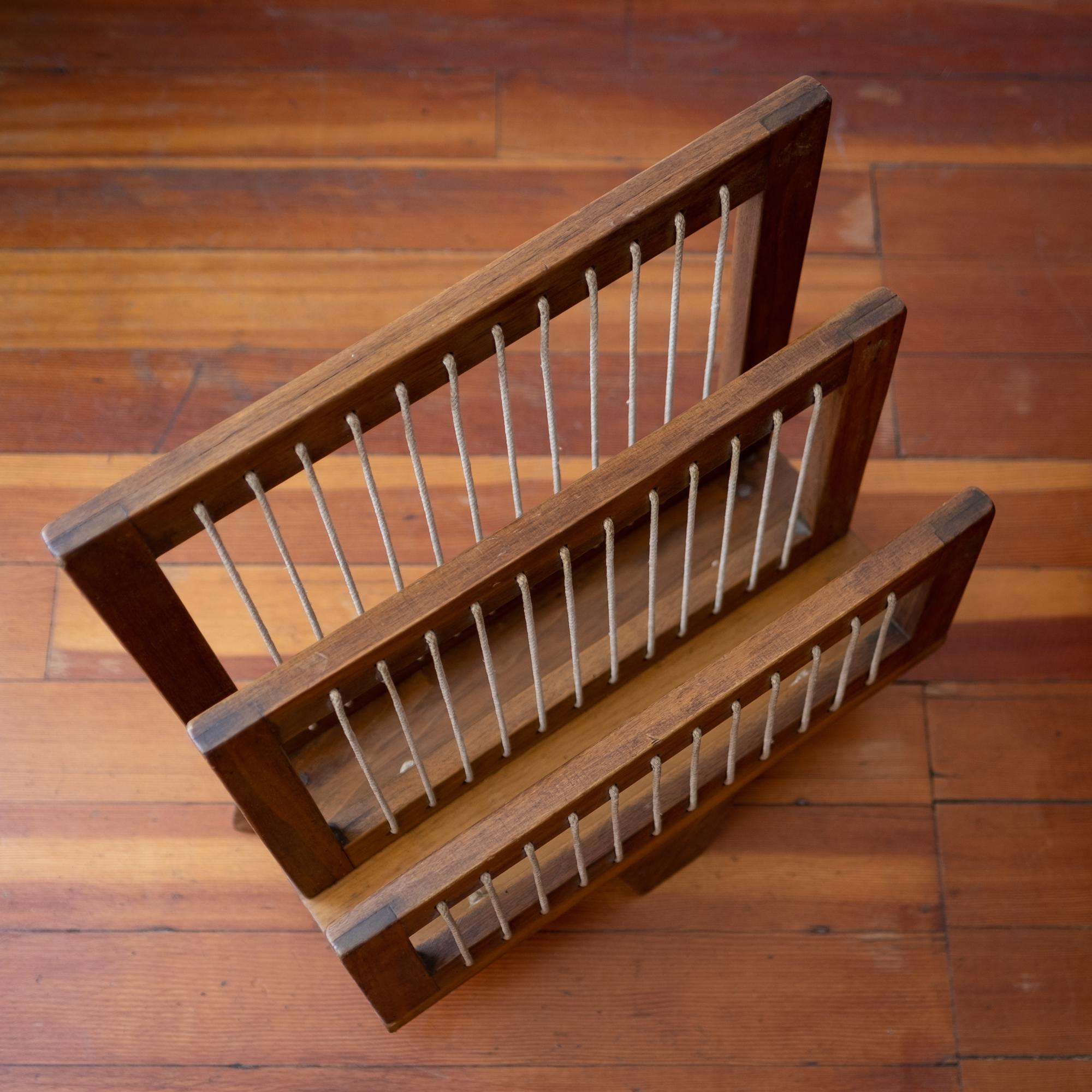 Handcrafted magazine rack constructed of wood and string. Original finish with a nice patina. Reminiscent of the modernist, yet rustic, Chandigarh furniture designed by Pierre Jeanneret, 1950s.