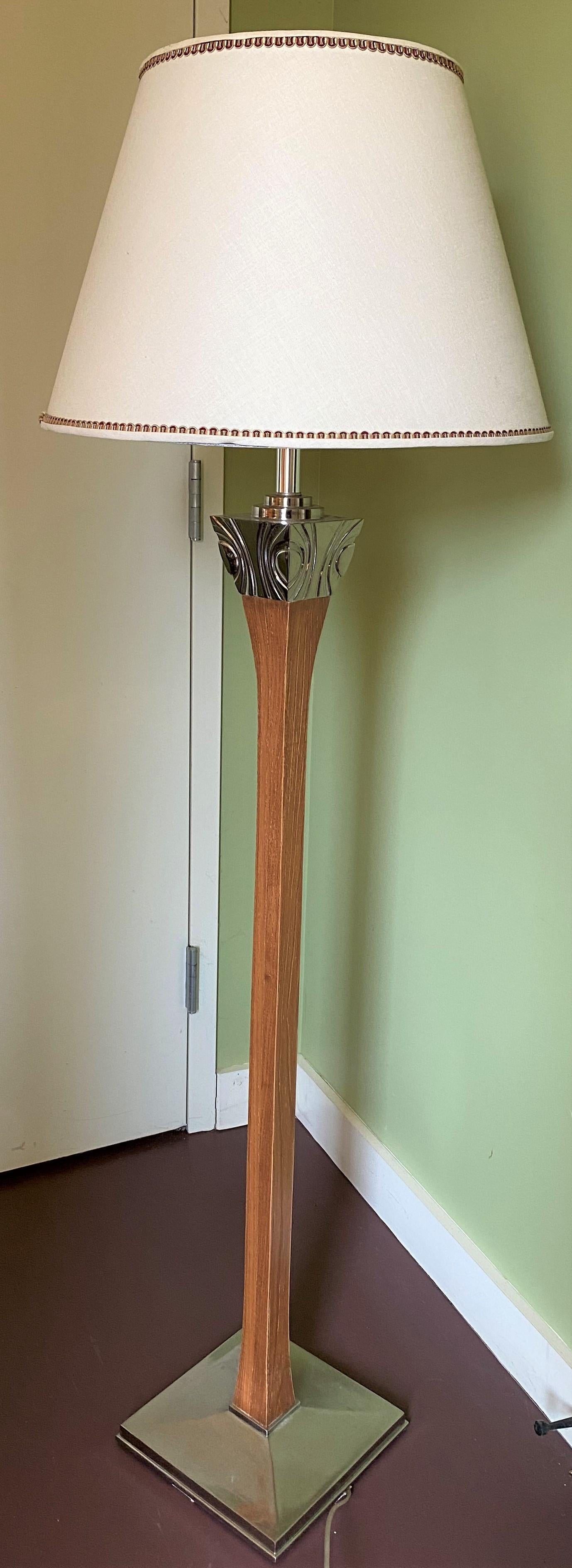 An attractive mid century heavy wooden floor lamp with silvered metal flared top decoration in the Art Deco meets MCM style and square silvered metal base, in very good working order with fresh wiring, minimal surface wear, and a few shade edge