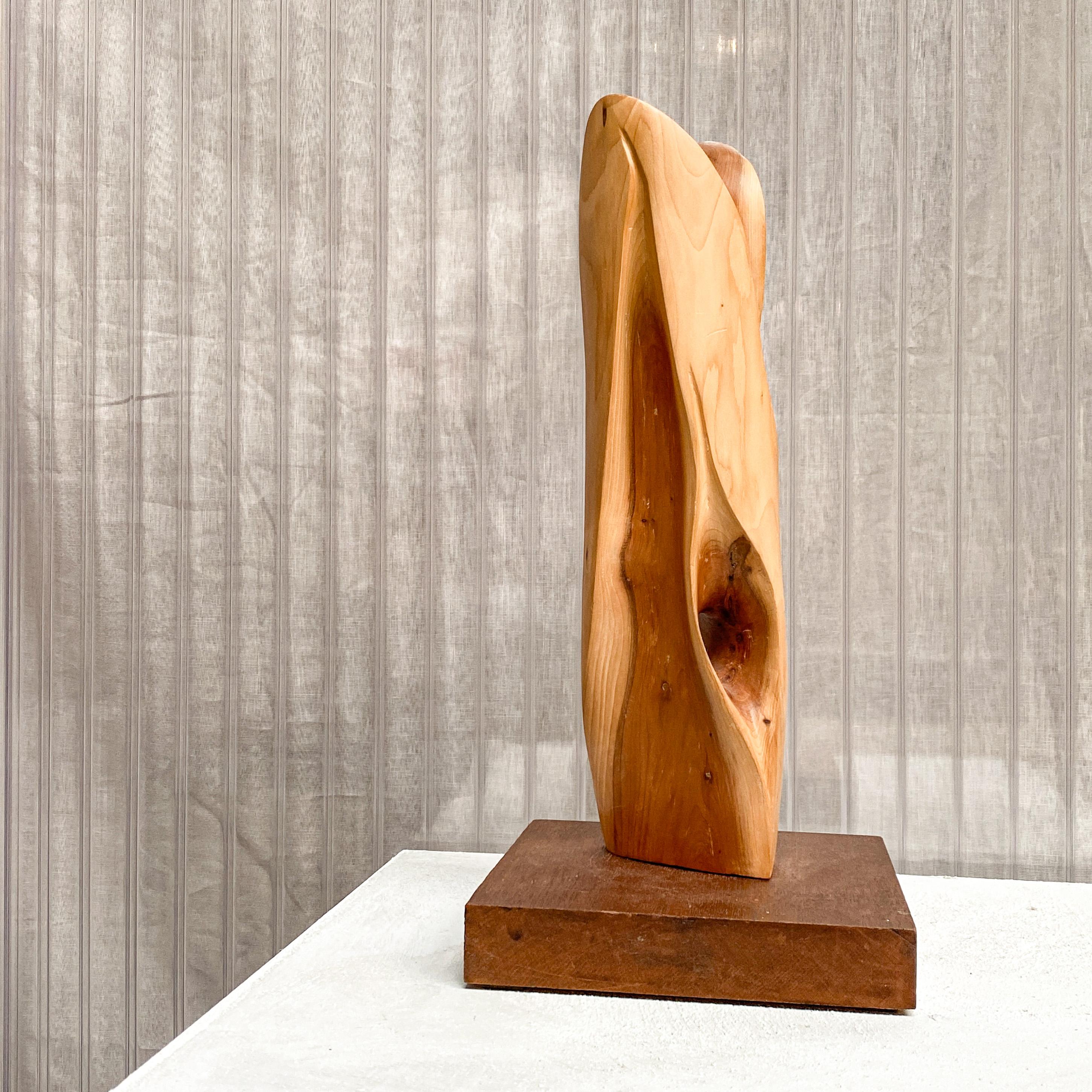 An amorphous and abstract piece by an unknown Artist. A hand-carved totem-like form made of natural wood form with a sculptural shape, typical of the 1960s/1970s. The wood with natural cracks and fissures.

The shape is mounted on a wooden base,