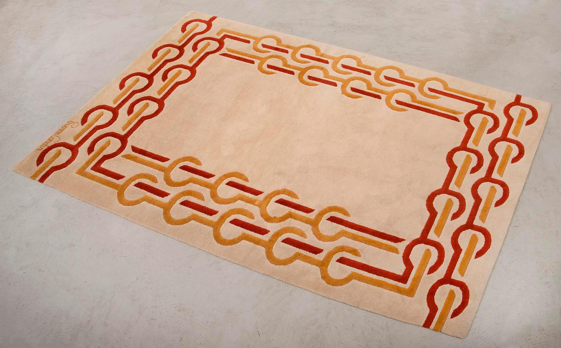 Elegant vintage wool rug designed in Pierre Cardin's Paris Atelier and made in Denmark by Scandinavian Folklore Carpets, 1970s. Vibrant interlocking colors in yellow and tomato red on cream background. Signed Pierre Cardin.