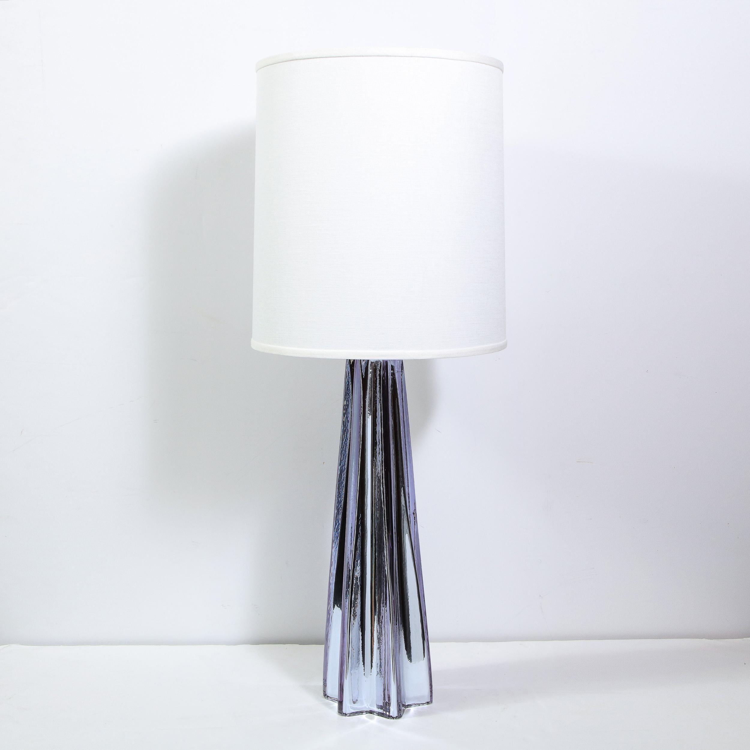 Hand blown in Murano, Italy, this stunning pair of mirrored mercury glass table lamps features a sculptural tapered x-form body in a rich lavender hue with nickel fittings that echo the silver tones found throughout the piece. With their subtle, yet