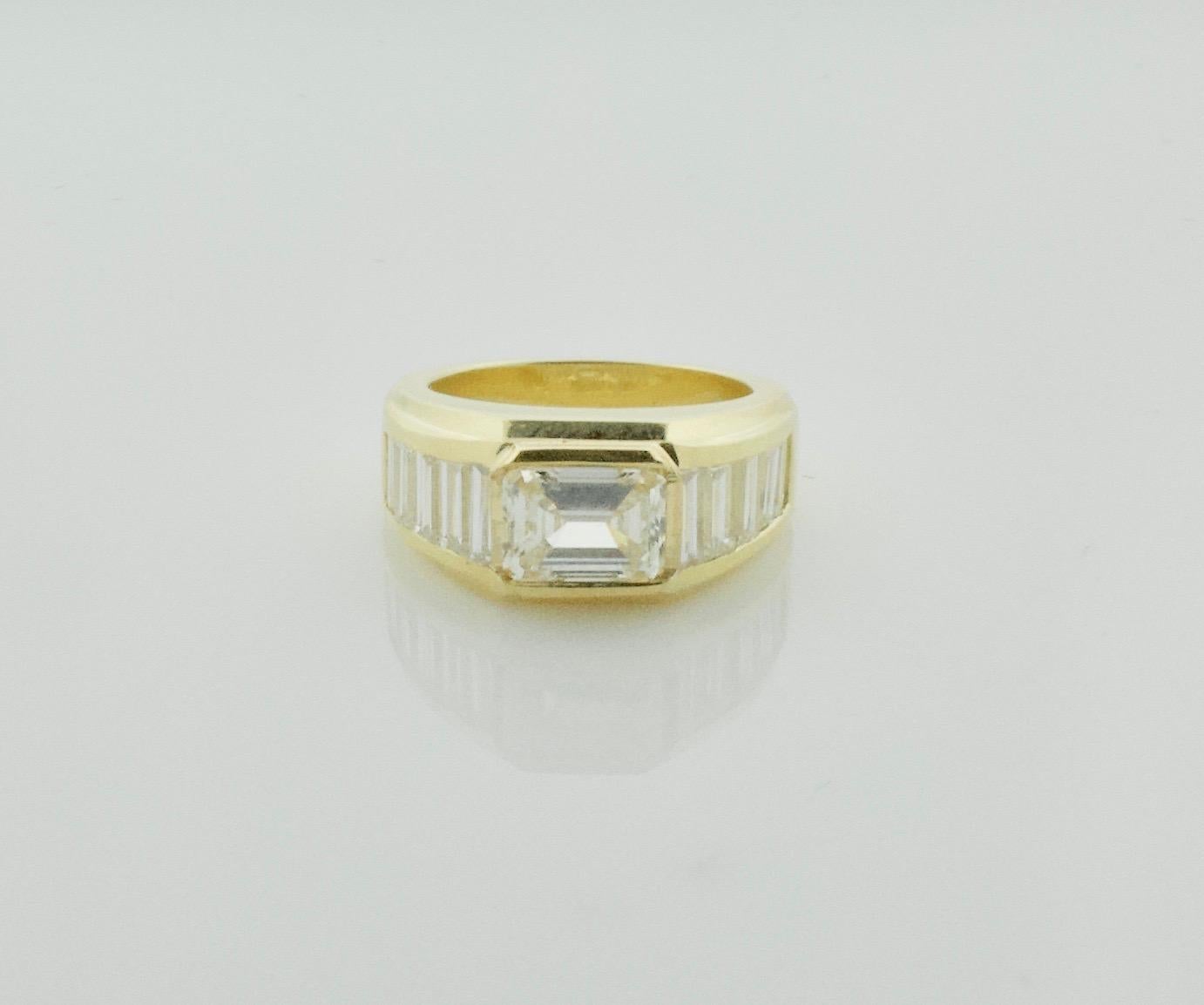 Modernistic East - West Diamond Ring in 18k Yellow Gold
One Emerald Cut Diamond Weighing 1.27 Carats [MN VVS]
Ten Baguette Cut Diamonds Weighing 1.55 Carats Approximately [IJ - VVS]
Currently Size 5 Can Easily Sized By Us or Your Qualified Jeweler