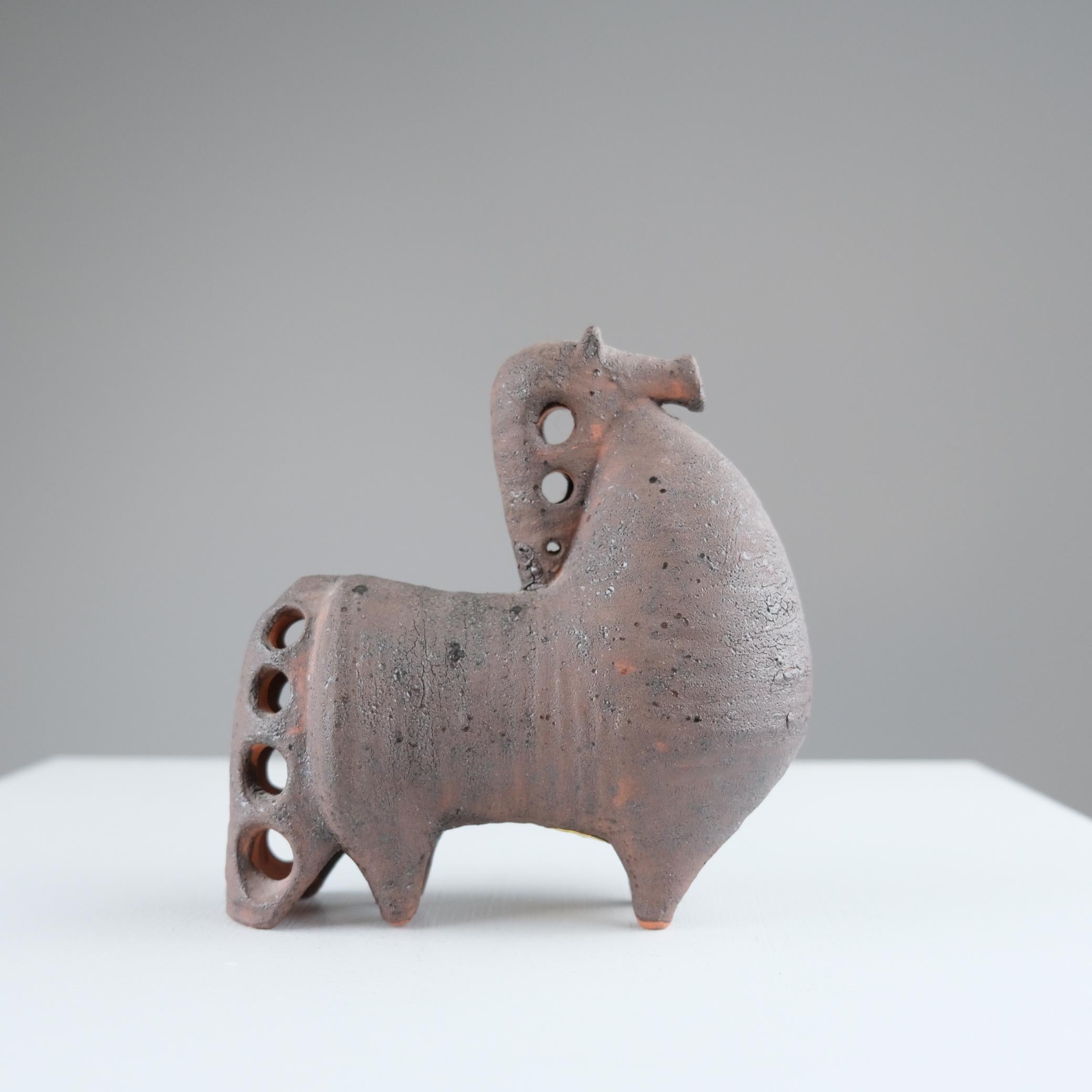 A modernistic red clay figurine by Finnish sculptor Viljo Mäkinen for Kupittaan Savi Oy, one of Finland’s most notable pottery and ceramic manufacturers of the mid-twentieth century. The piece carries Mäkinen’s characteristic touch of gentle humor,