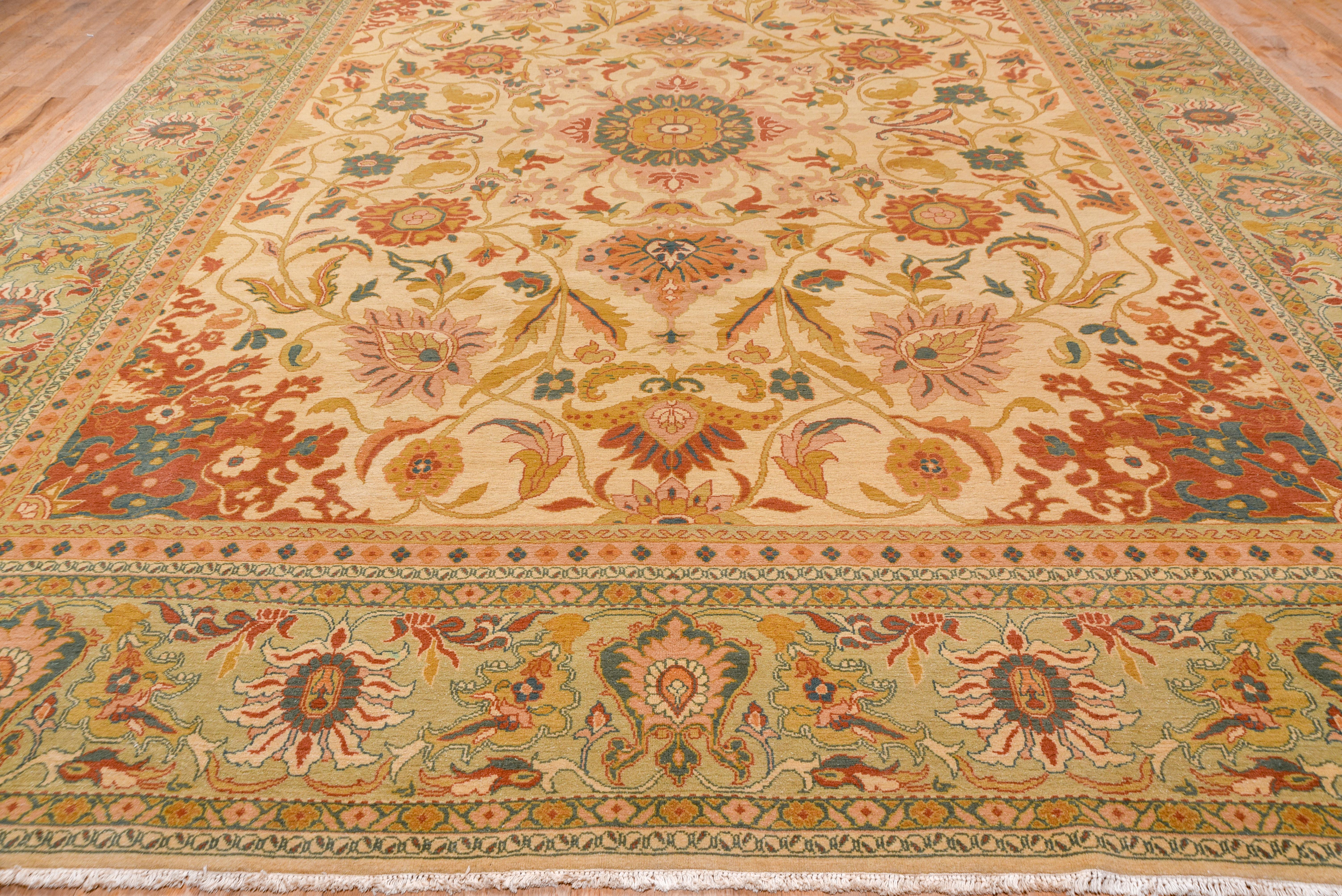 This quite effective modern interpretation of an antique west Persian village carpet shows a pointed octagon central motif with palmette pendants, a surrounding fill of other palmettes, leaves and vines, and flaming floral corners, all on a sandy