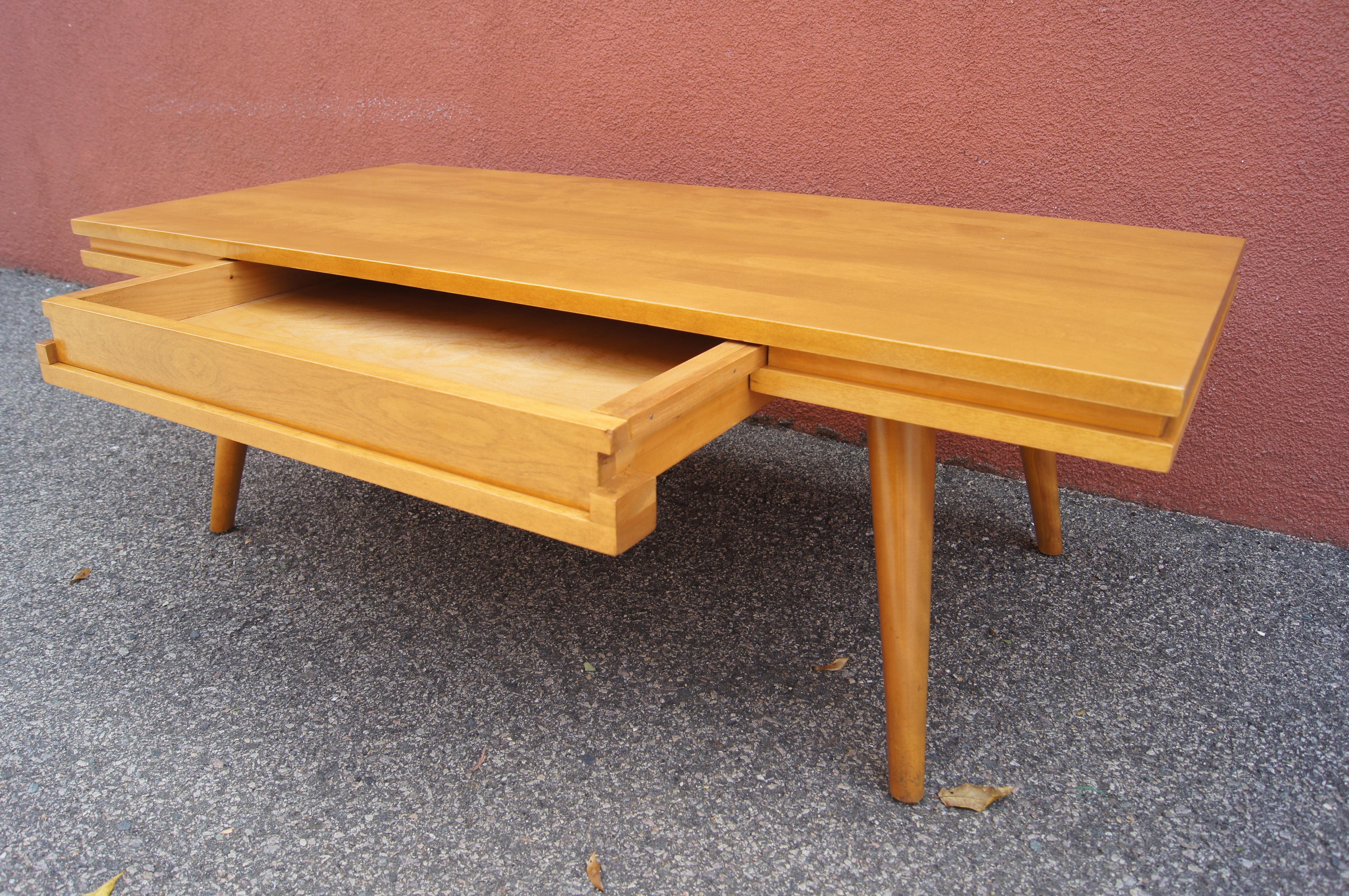 Designed by Leslie Diamond for Conant Ball's Modernmates line, this solid birch coffee table features a wide shallow drawer perfect for tidying away remotes and other objects.

   