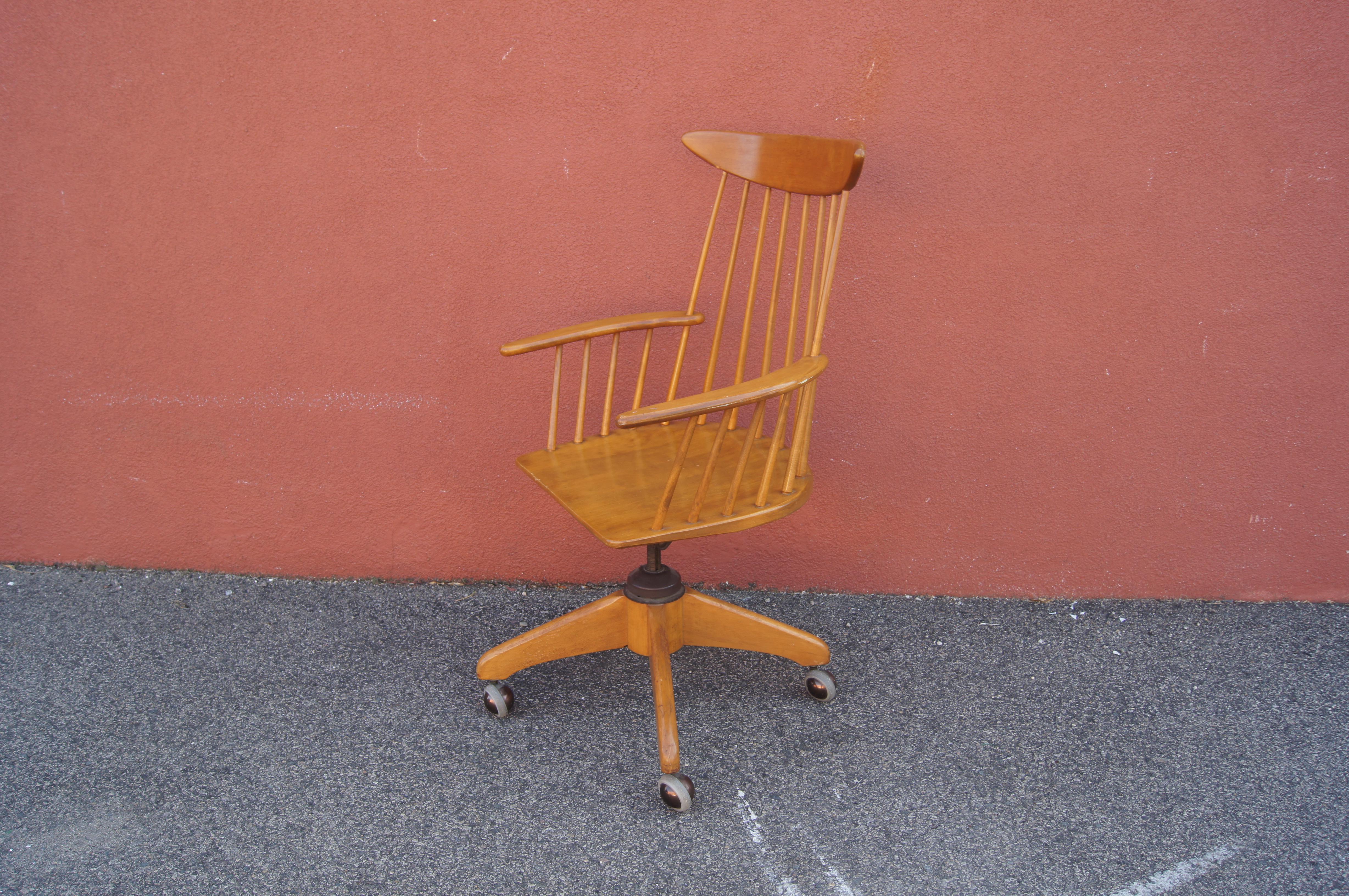 Part of Leslie Diamond's ModernMates line for Conant Ball, this birch chair turns the form of a classic Windsor chair to home office use with a swiveling seat on casters. The seat height adjusts from 15 to 18 inches and a knob allows for the tilt to