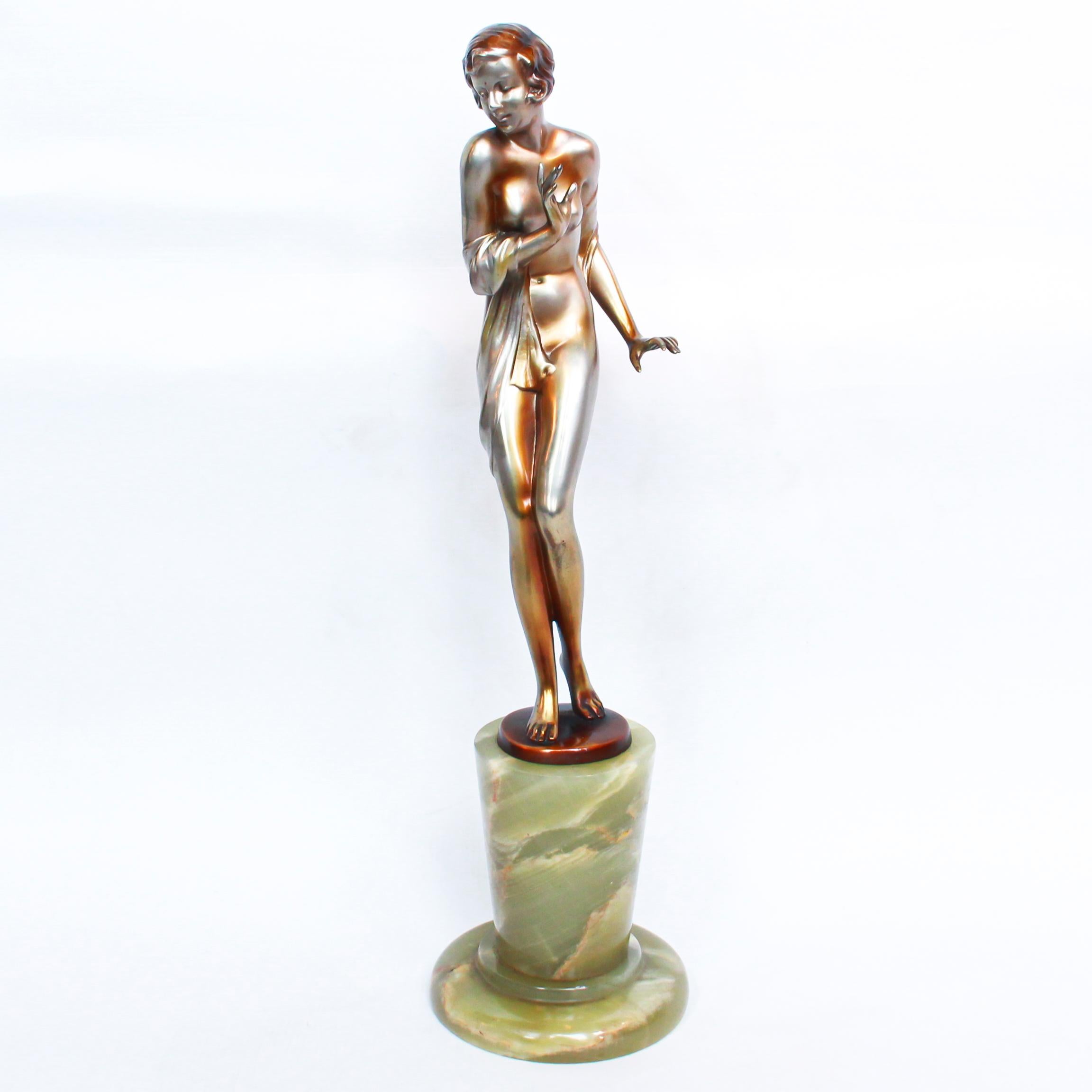 An Art Deco, cold painted silver and enamel bronze figure of a young woman wrapped in a shawl with fine color and detail, raised on a stepped conical green onyx base. Signed Lorenzl to cast.

Josef Lorenzl , born in 1892 began his career at a
