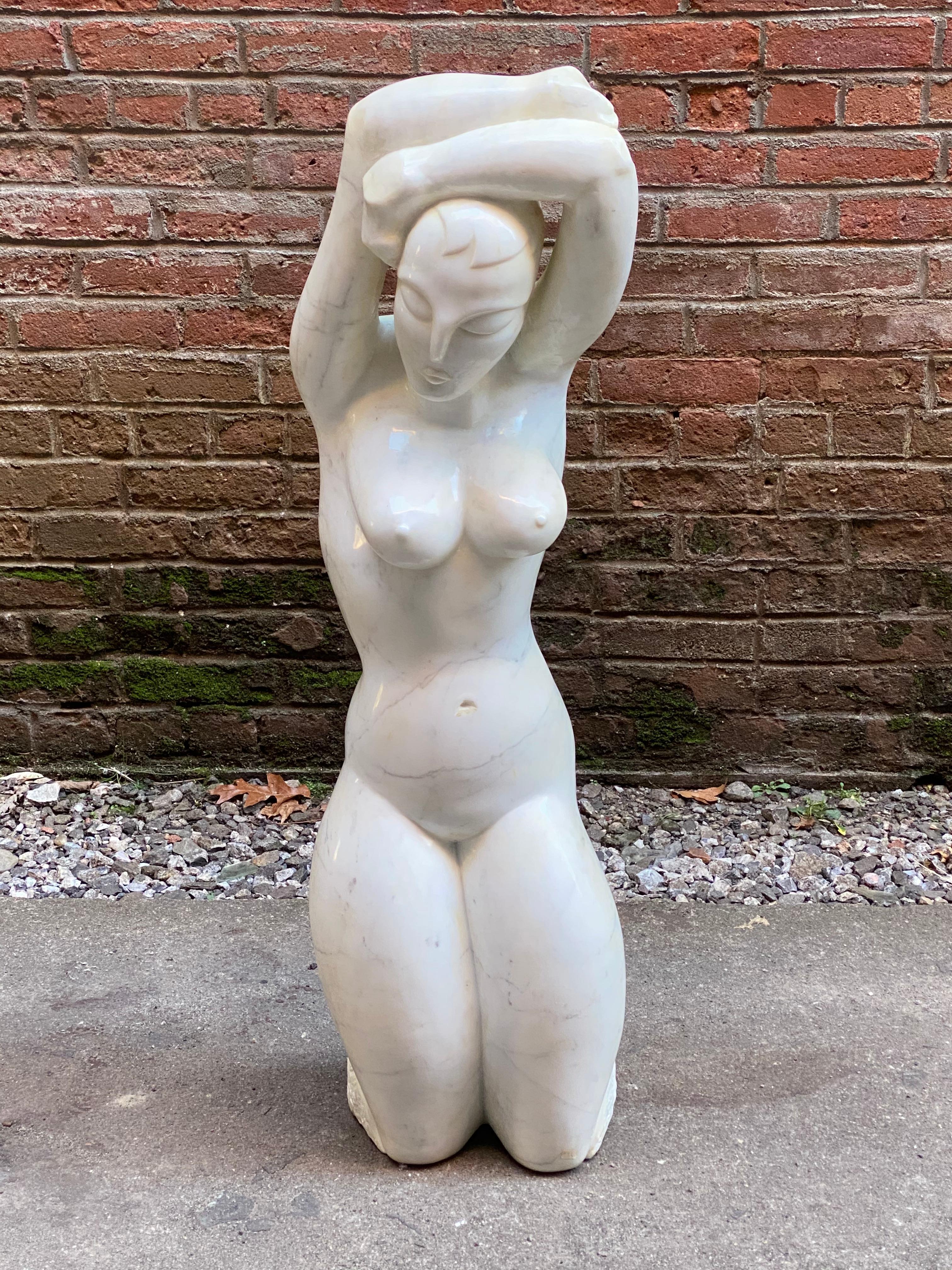Sensual female nude Carrarra marble sculpture by Anthony Gennarelli. An homage to Amadeo Modigliani, circa 1980-1985. The artist has depicted this curvaceous figure with arms raised in a very natural counter poised standing position. Truncated at