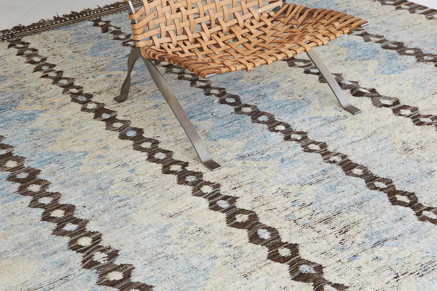 The 'Modlina' rug is a handwoven wool piece inspired by vintage Scandinavian design elements and recreated for the modern design world. The rug's shag balance and harmony, handwoven with a neutral flat weave and unique piles of earth tones. This
