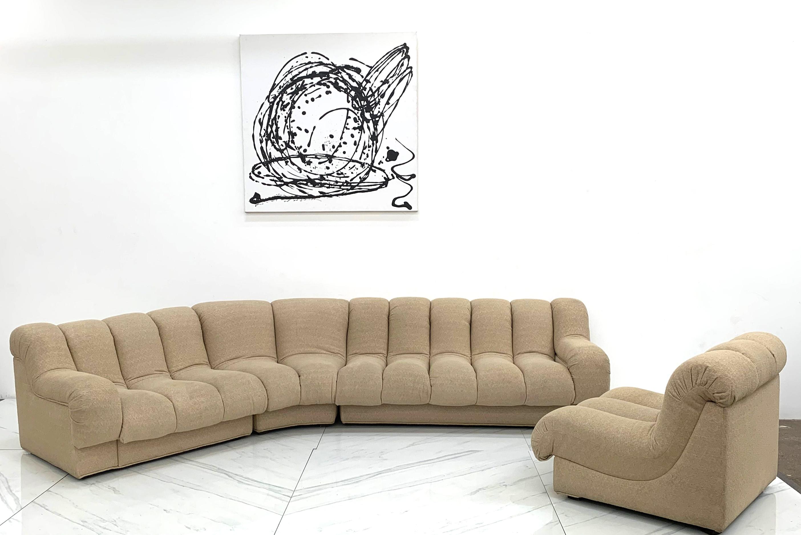 This sofa is absolutely stunning! A 1990's 4 piece modular sectional sofa that could easily be mistaken for a De Sede DS600. This nonstop style sectional features a channel tufted design that's unmistakably modern and is very much De Sede or Steve