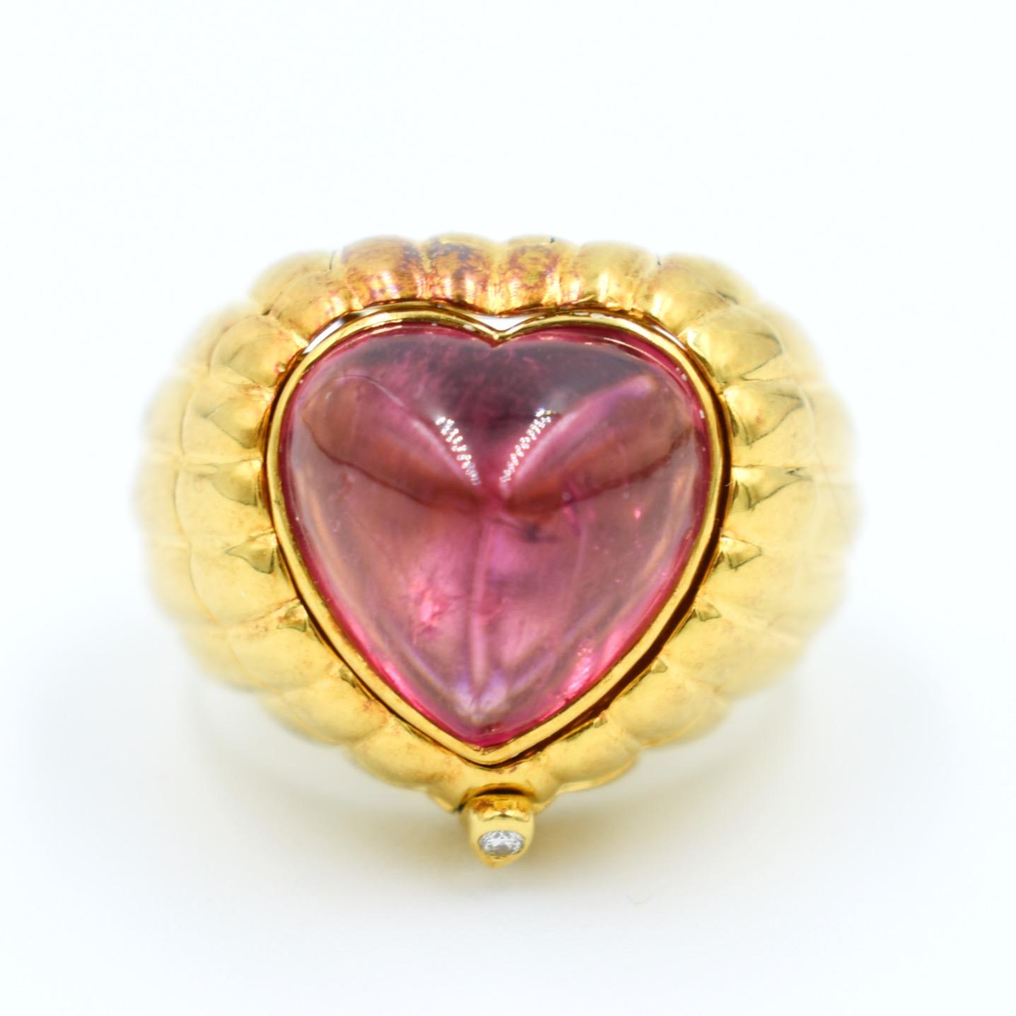 This is a 1994 Simon & Igal designer ring in the shape of a heart. This vintage ring is a true gem with multiple facets, customizable according to your preferences. Made of 18-carat gold, it features three heart-shaped cabochons: a tourmaline, an