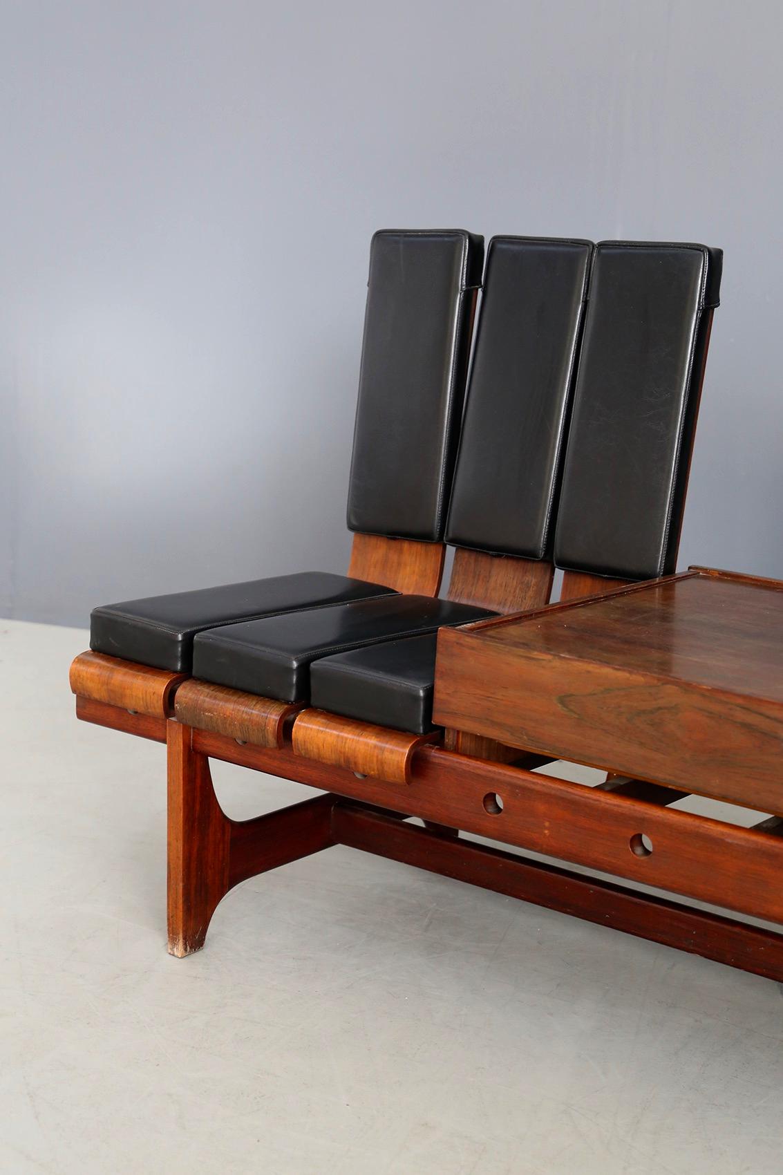 Modular bench by Barovero Torino in rosewood and black leather. Midcentury bench made by Barovero Torino in 1955. The bench is modular with a dark veined rosewood drawer. The seat is striped in black leatherette. The peculiarity of the bench is its