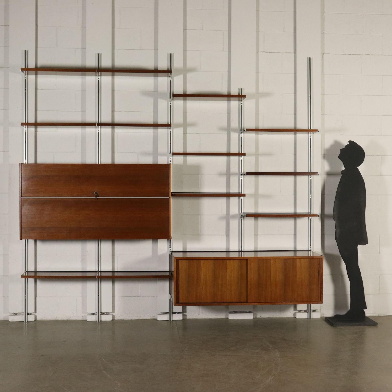 Modular wall bookcase designed by Osvaldo Borsani (1911-1985) for Tecno. Adjustable aluminium rails and supports, walnut and wood veneered shelves and containers. Model: E22. Manufactured in Italy, 1960s.