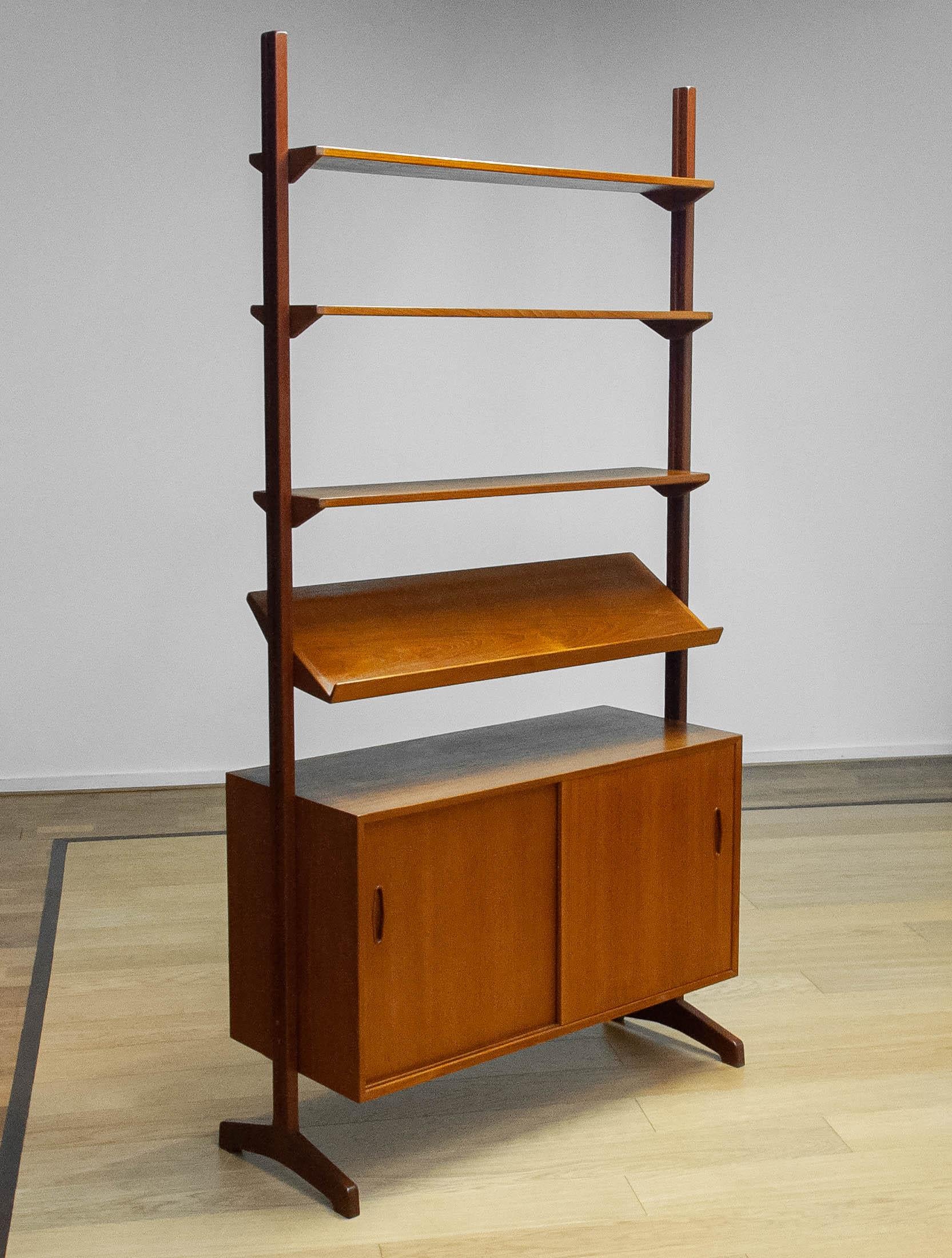 Beautiful teak 'all in one' masterpiece cabinet 'model Domi' designed by Nils Jonsson for Hugo Troeds Sweden. ( displayed in the Bra Bohag catalogue ) This fee standing modular system can de used as a room divider as well. All shelfs are adjustable