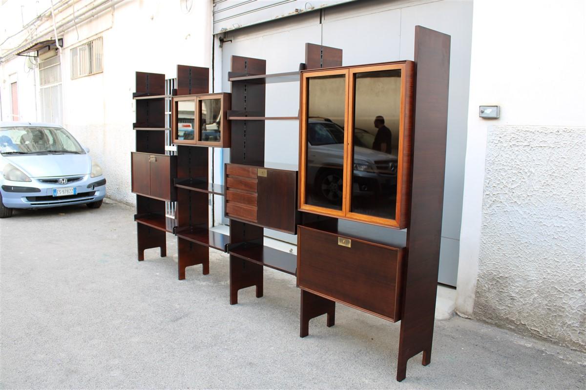 Modular bookcases Vittorio Dassi midcentury Italian design brown wood rosewood.

we include a riser in the sale, so you could extend it further by 80 cm to 413 cm, remodeling all the elements of your choice.