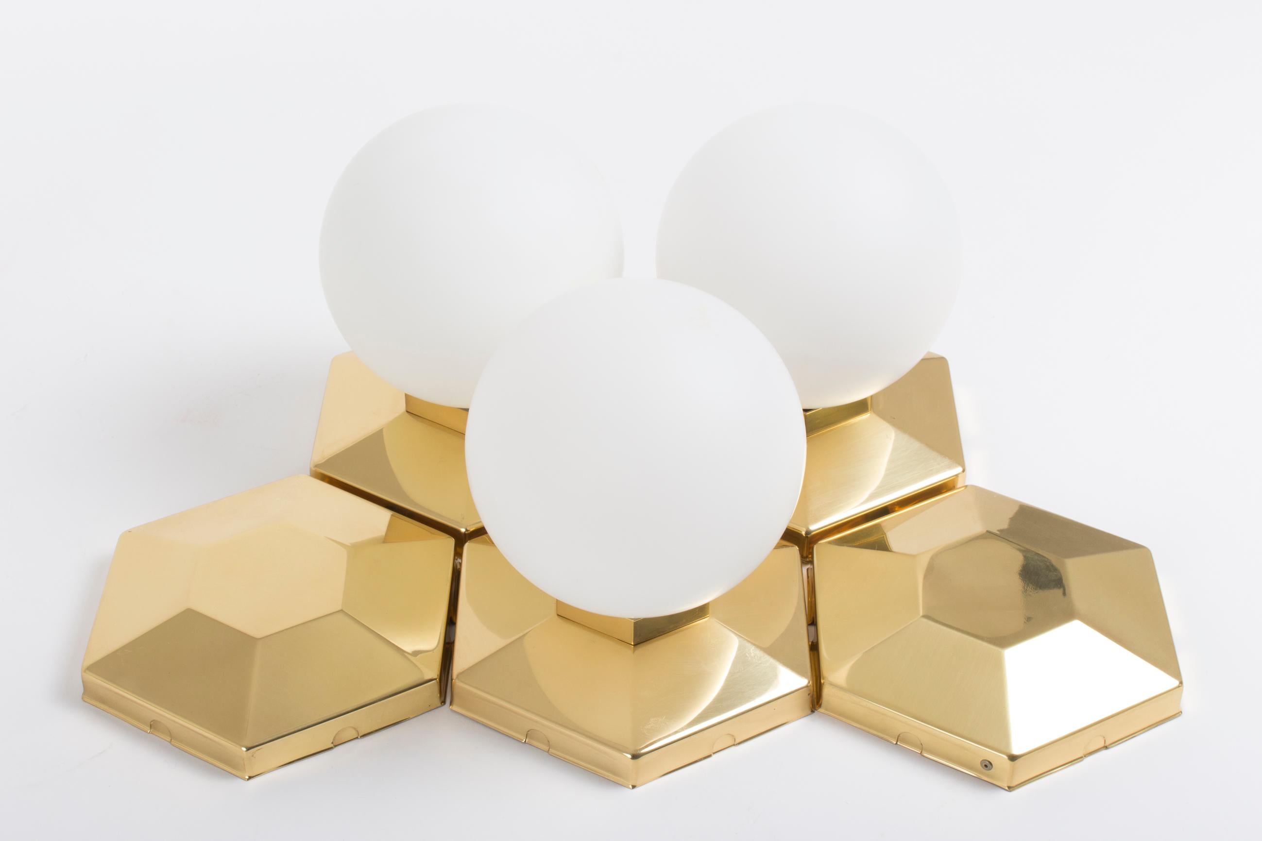 Set of multiple brass and glass flush mounts for modular installation, priced per piece (blank or opal glass-sphere) from 1970's- Design by Rolf Krüger for Neuhaus.

They will also work as wall mounted lights.

We have 40 pieces with opal glass