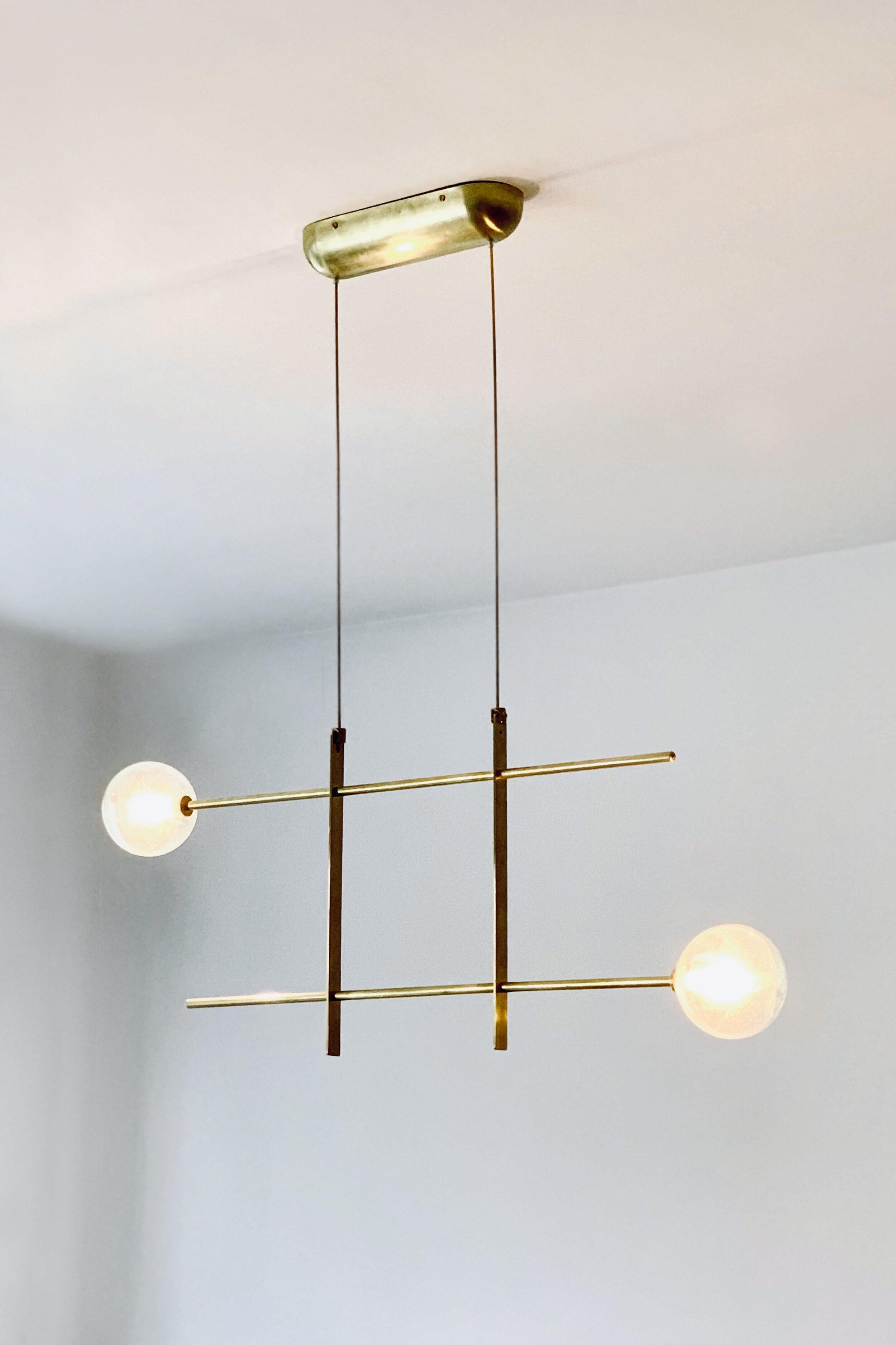 Modular chandelier 2 lamps by Contain
Dimensions: D 80 x W 32 x H 100 cm (custom length).
Materials: Brass structure, cristal blown from local production.
Available in different finishes and dimensions.

All our lamps can be wired according to