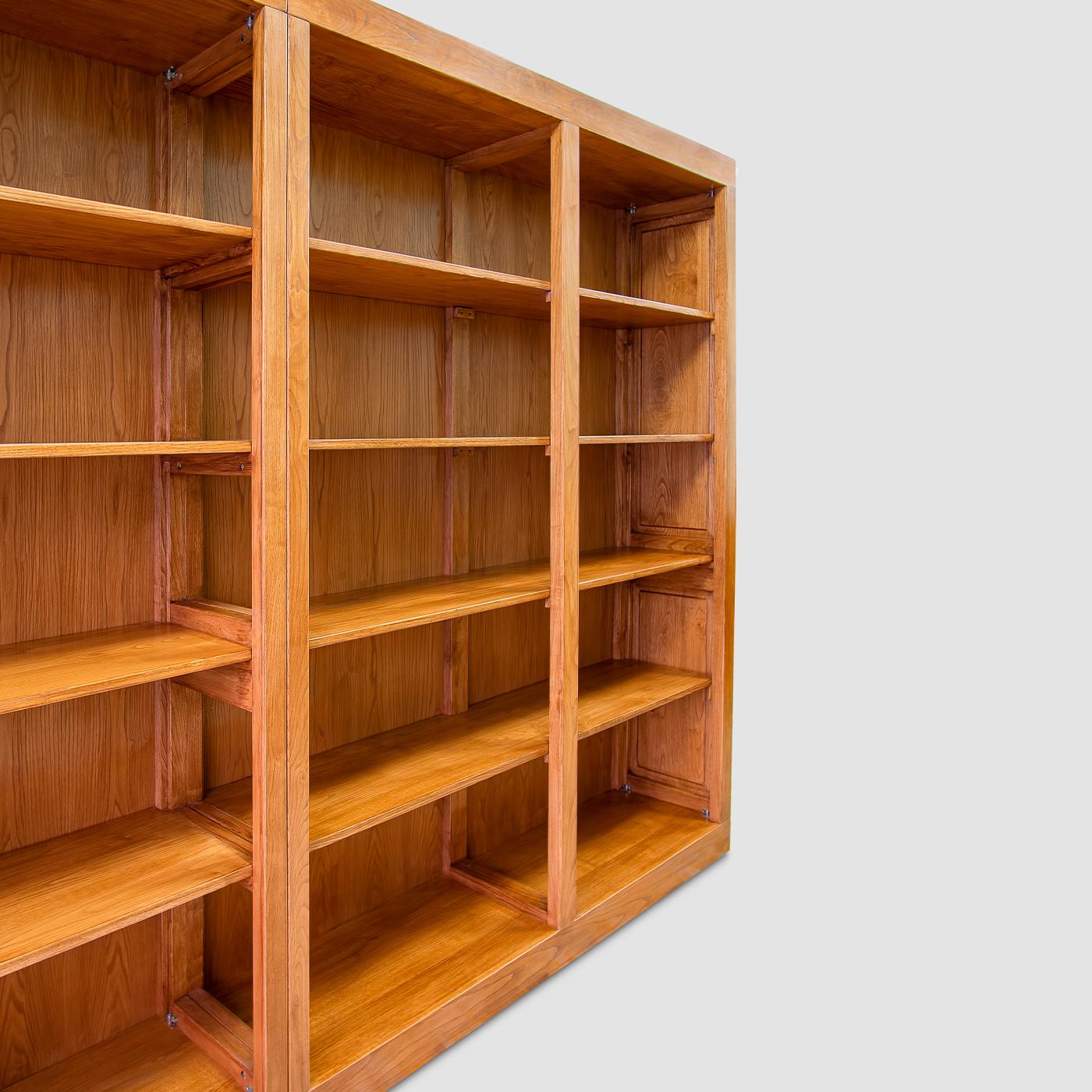 This meticulously handcrafted modern bookcase showcases the warmth of solid chestnut wood grain, here offered in a nontoxic, walnut stain variant enhanced with beeswax. Concealed leveling feet ensure excellent support for the two shelving units,