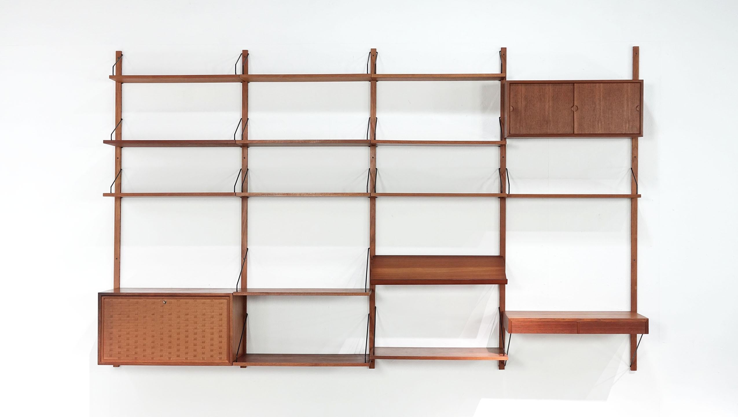 Cado Royal system shelf designed in 1948 by Poul Cadovius for Cado, Denmark. Teak wood with black brackets. A drawer unit with four drawers, a desk and a box with sliding doors.