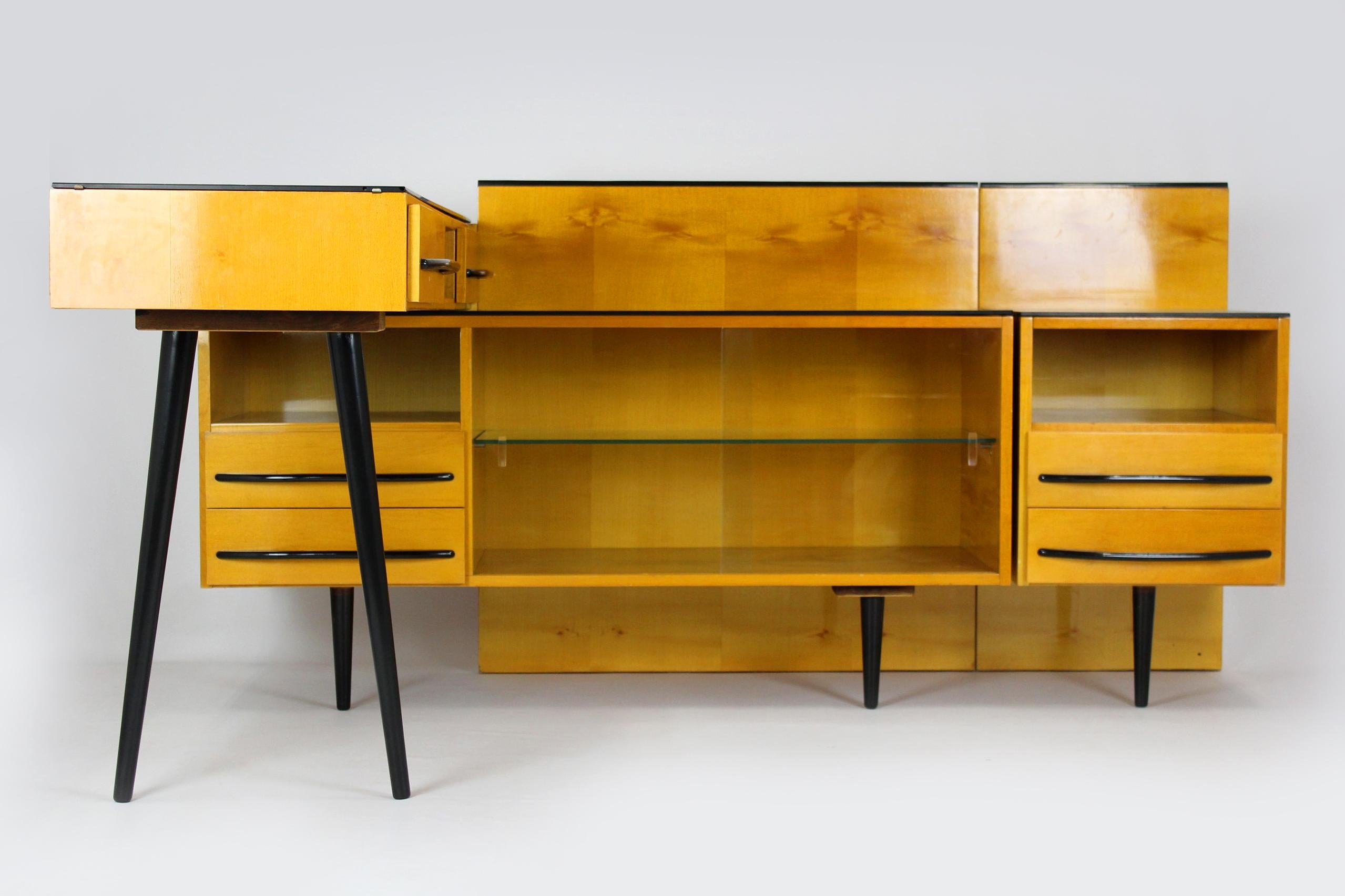 This vintage furniture set was designed by Mojmir Pozar and produced in the 1960s in the Czech Republic.
The set consists of three elements:
- smaller cabinet: 40x42x60cm
- larger cabinet: 120x42x60cm
- desk: 120x40x75cm
They can be combined in