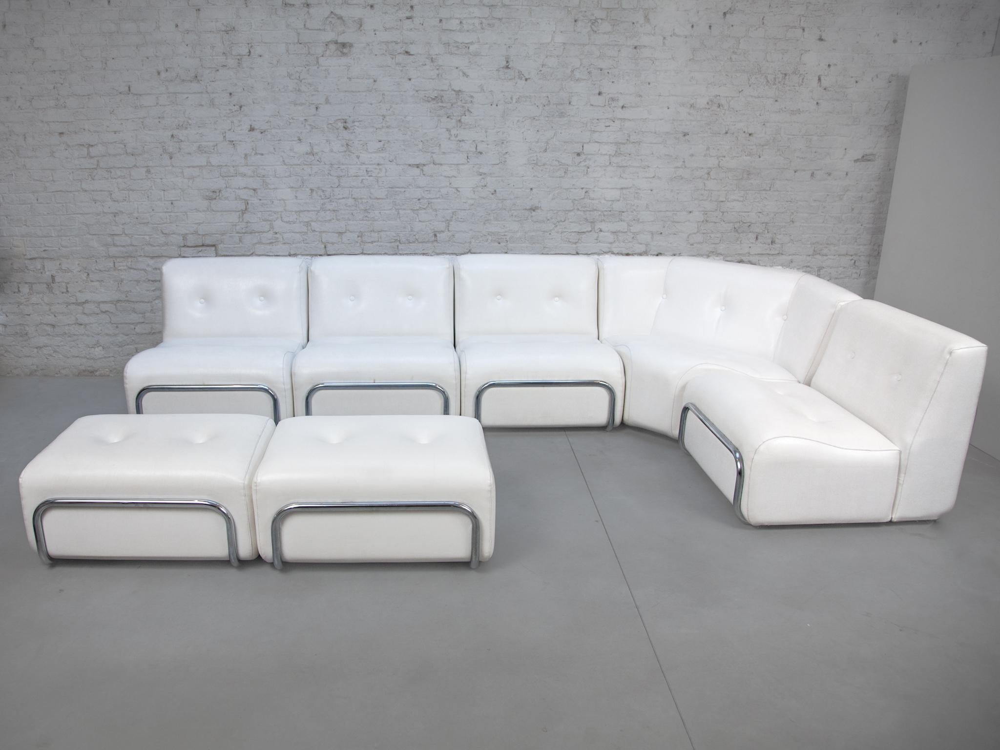 A living-room set of Adriano Piazzesi, Italian 1960's. Beautiful white tufted faux leather lounge chairs, corners and footstools, with chrome-plated tubular steel curved supports in front and back sides, the front and back tubes showcasing the seats