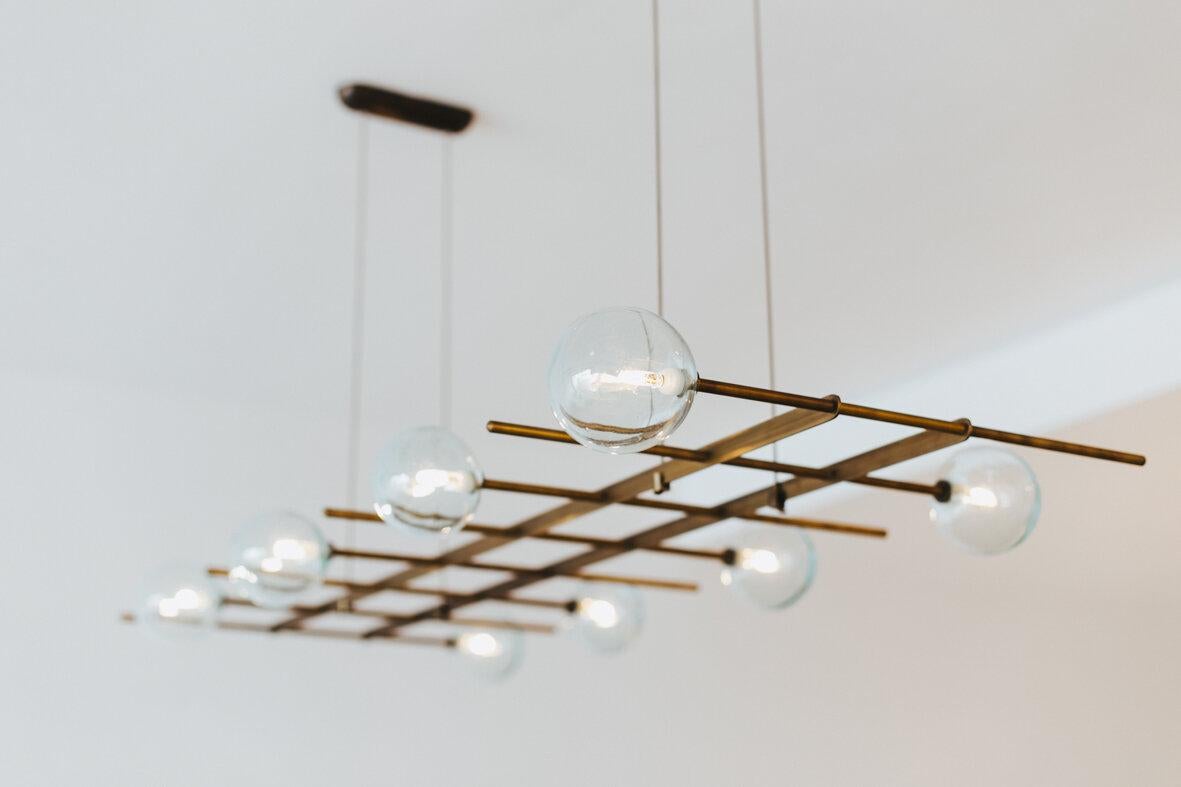 Modular fat 8 lamps pendant by Contain
Dimensions: D 130 x H 54 cm (custom length).
Materials: Brass structure, blown glass from local production.
Available in different finishes and dimensions.

All our lamps can be wired according to each