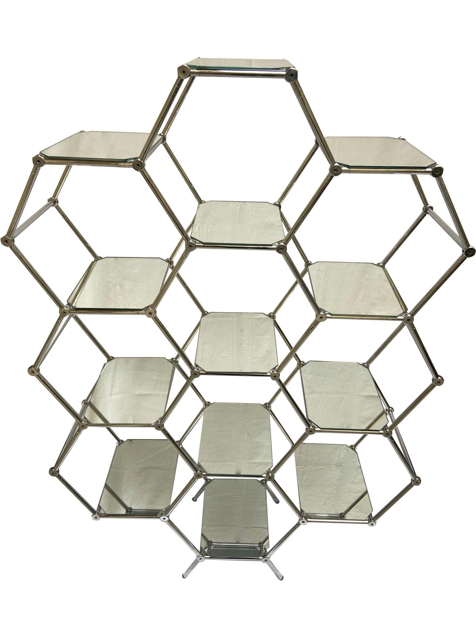 Étagère hexagonal honeycomb display. Modular chromed metal structure fixed with joints and mirrored glass plates that create 10 hexagonal spaces to display your most expensive collection.