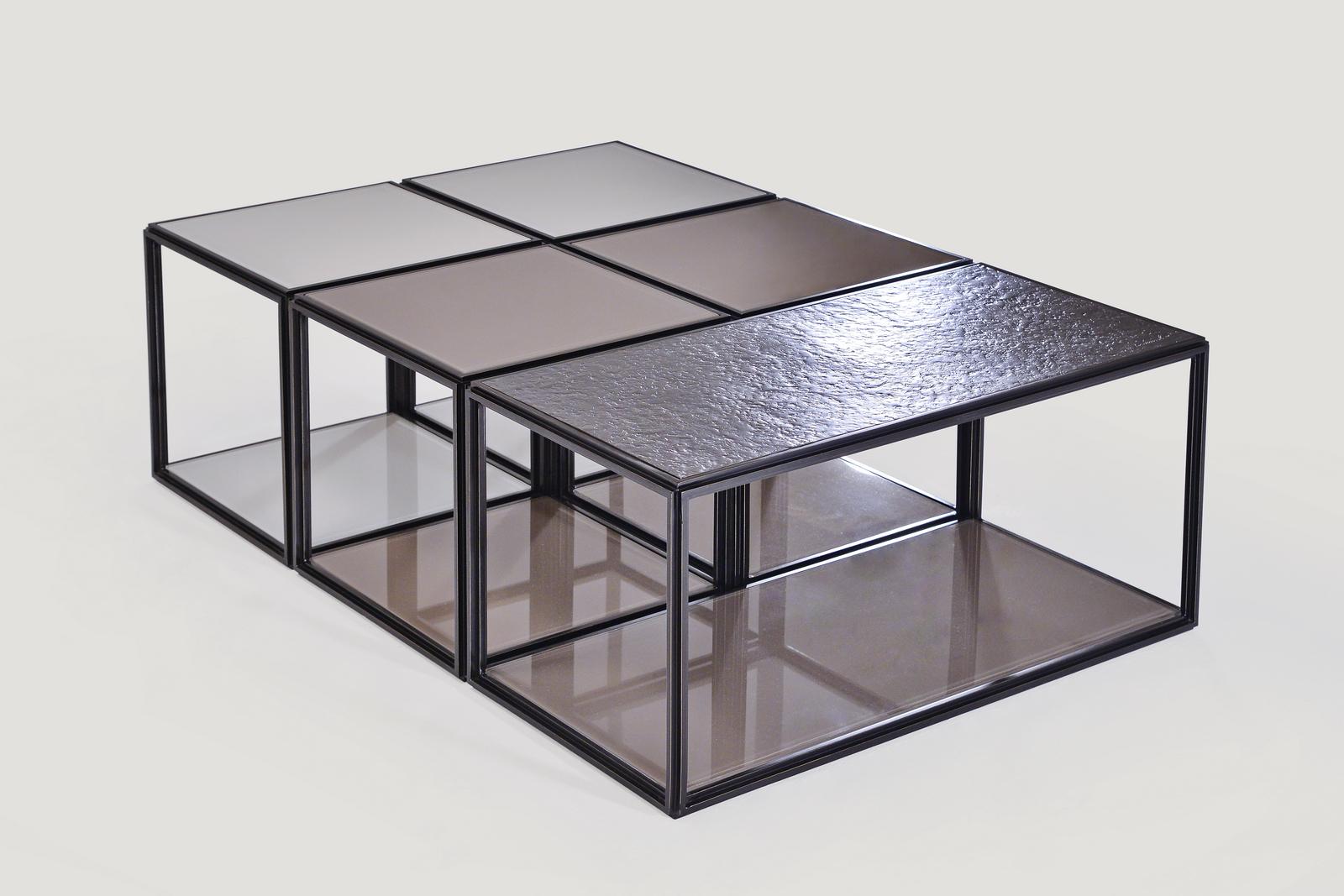 Modular coffee-table, by P.Tendercool

This modular table for a Houston-based interior designer.
He opted for a series of muted colors: blackish-brown lacquered brass frames, a textured bronze top, matched with subtle tones of browns and beige for