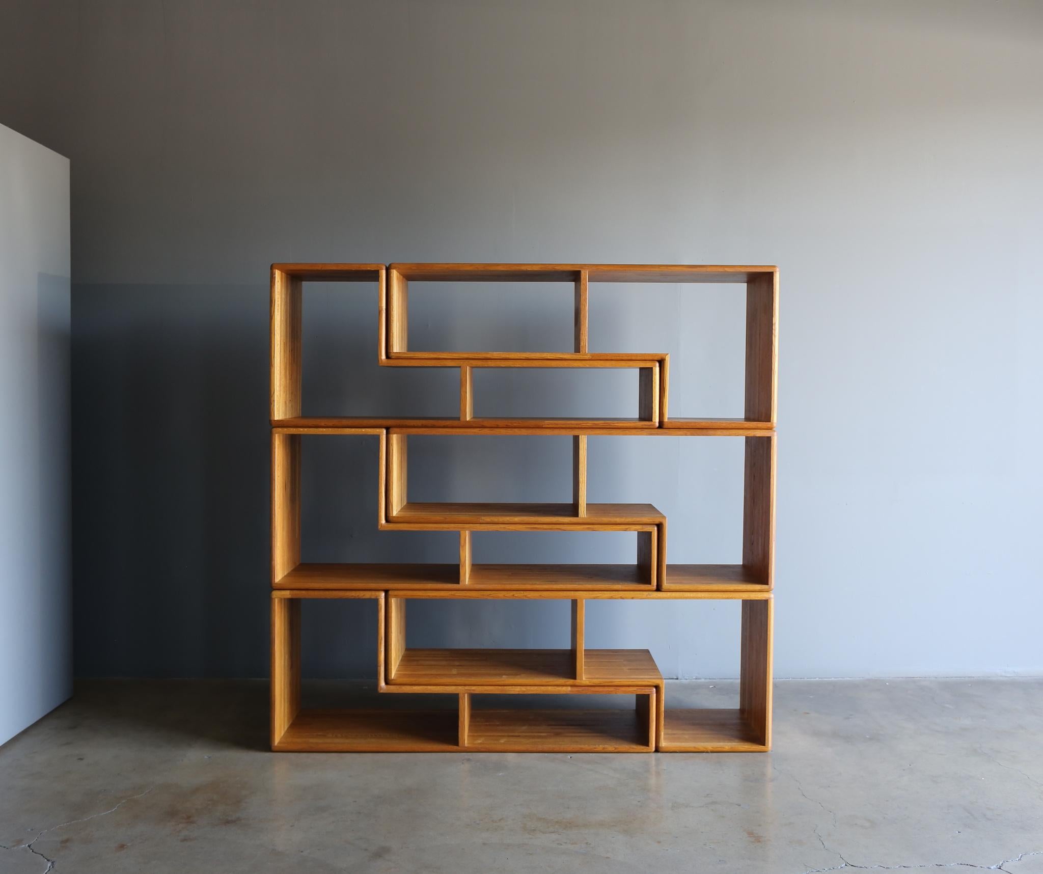 Modular oak bookcase, circa 1975. 

This set includes six pieces. 
The overall measurements per piece is 60” W x 25” T x 17.75” D.
Three pieces have one side that measures: 10.5