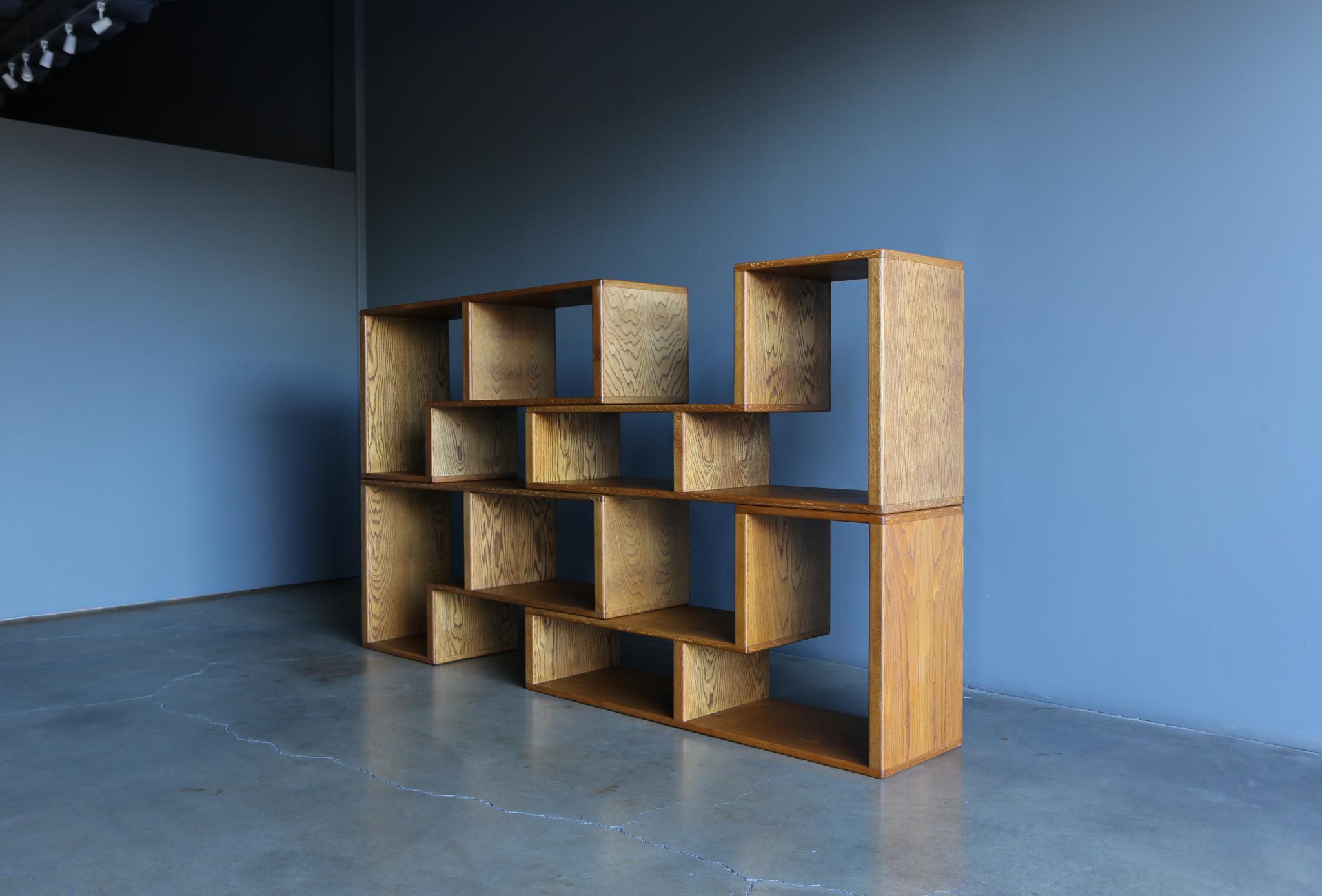 Modular oak bookcase, circa 1975.

This set includes four pieces.

The overall measurements per piece is 60” W x 29.13” T x 18” D.
Two pieces have one side that measures: 17.13