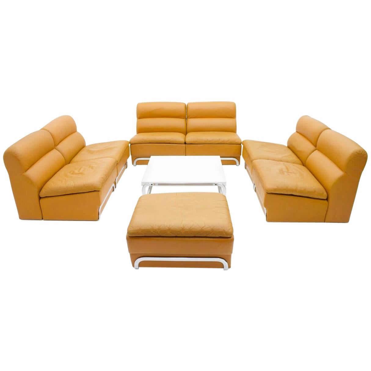 Rare modular seating group with foot stool and a coffee table by Horst Brüning for Kill International, Germany, 1970s.
Six elements and a foot stool in cognac brown leather with a steel frame. 

Very good condition.

Measurements:

Single seat: T 85