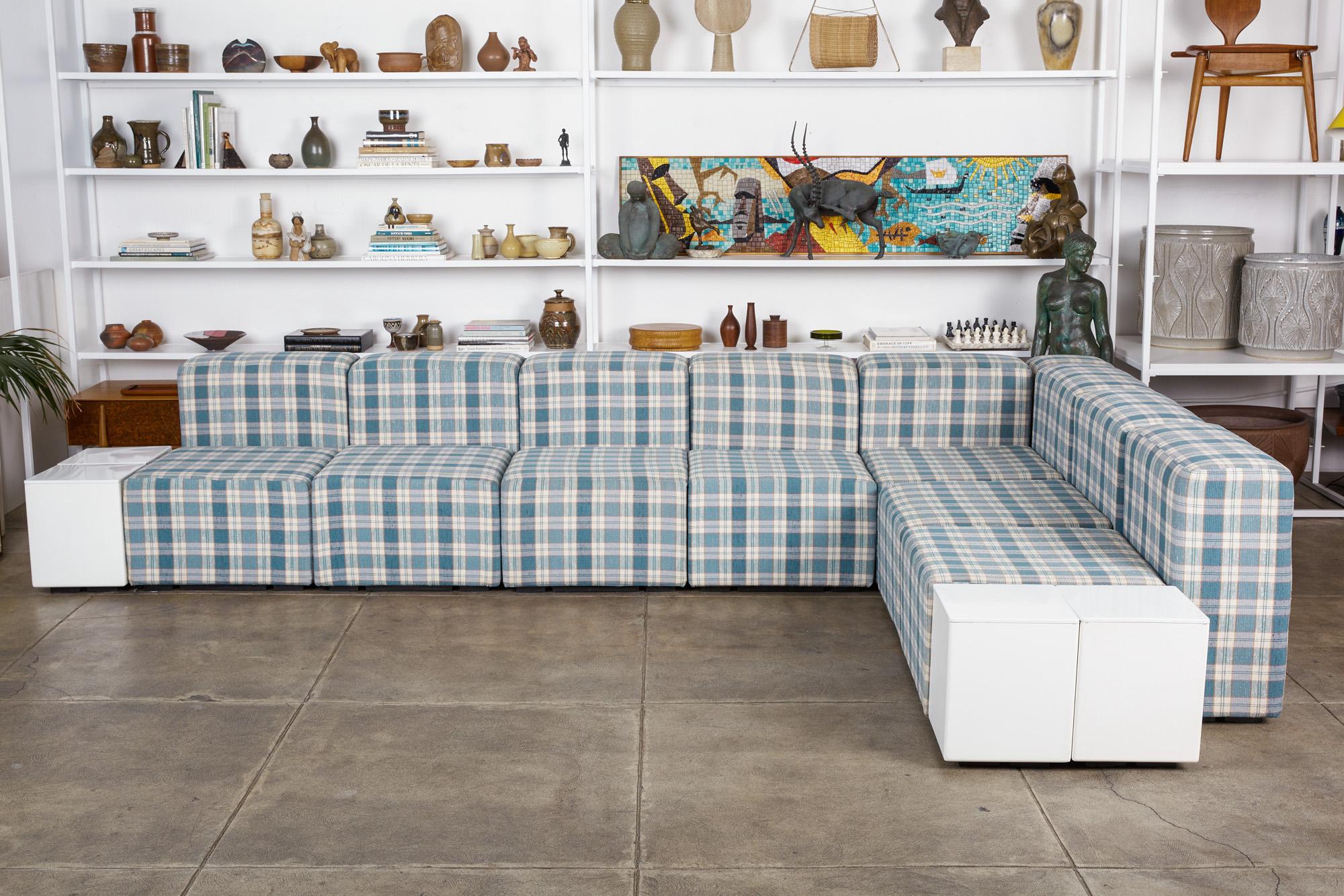 “Sistema 61” modular seating system by Giancarlo Piretti for Anonima Castelli, Italy, circa 1970s. The sectional features seven seating blocks, eight back/armrests, and one corner piece, all upholstered in an amazing blue plaid linen. The set also