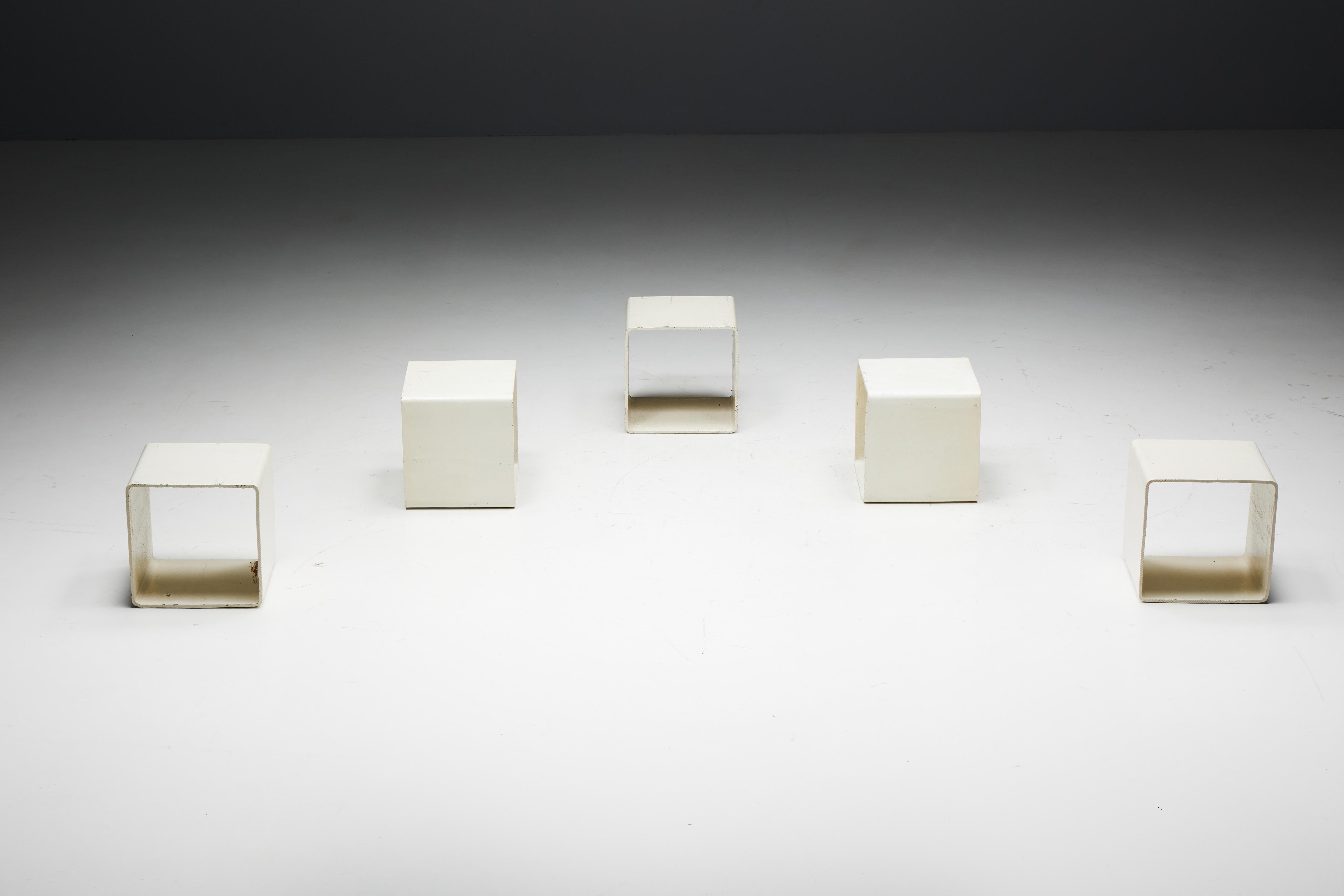 Willy Guhl's modular cubic side tables for Eternit AG, handmade in Switzerland in 1954. Each piece is a testament to Guhl's innovative design ethos, handcrafted with precision from fiber-reinforced cement and finished in an off-white lacquer. With